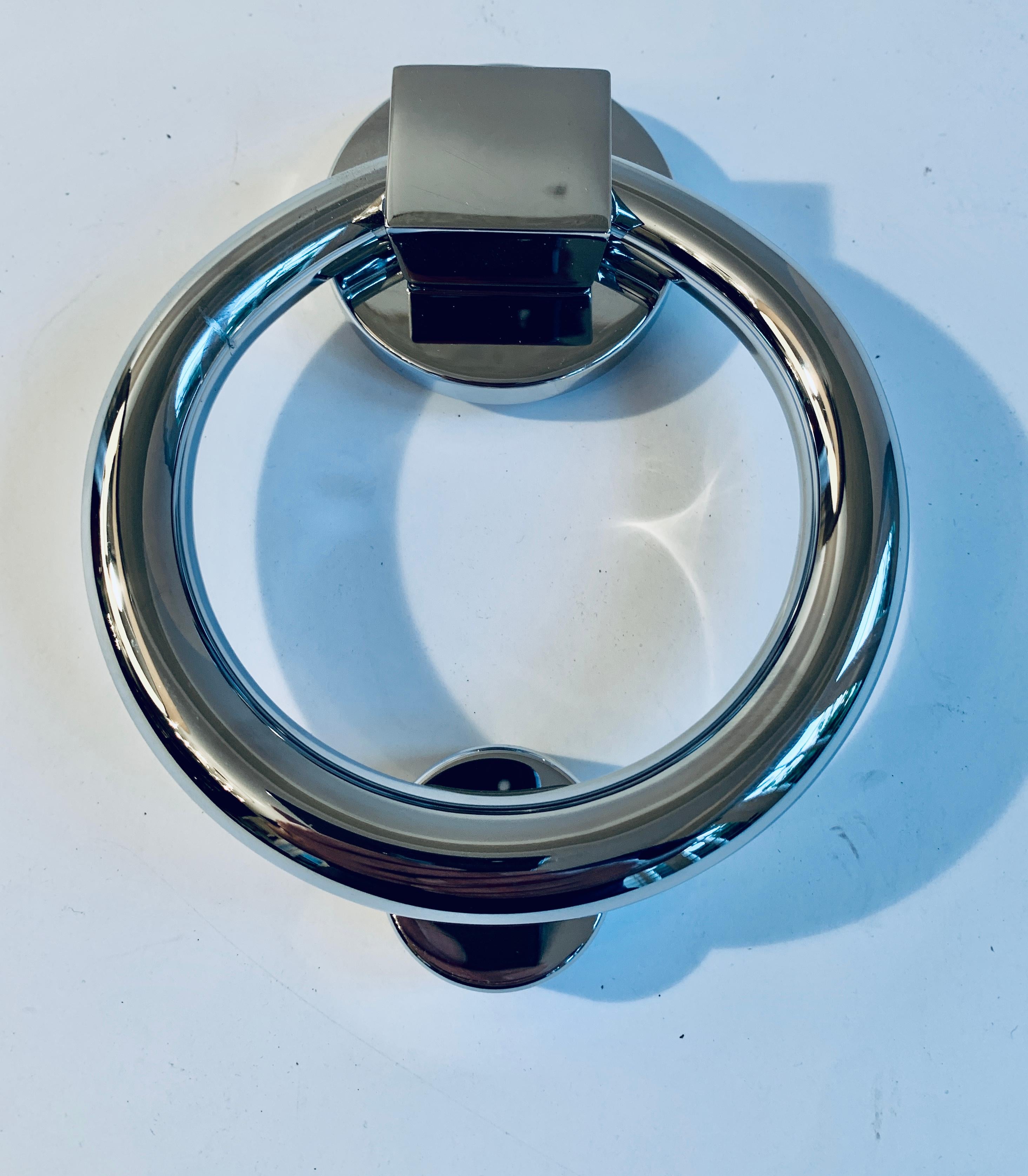 Polished chrome door knocker, a wonderful never used chrome piece, polished and ready to install, the knocker has small piece to hit, comes with adequate hardware for immediate installation.