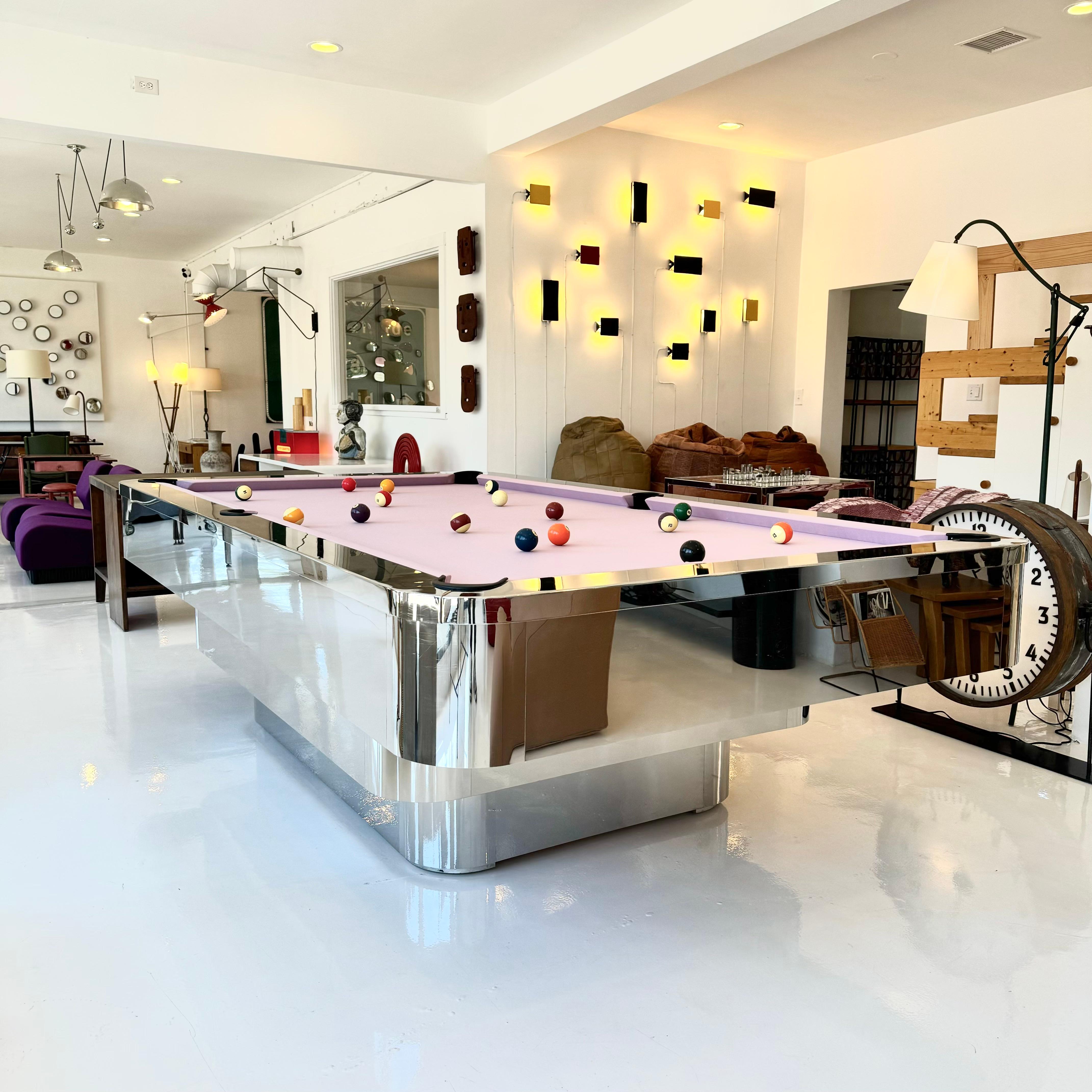 Stunning custom polished chrome pool table made in the 1980s. Professional sized 9 foot table. Table consists of three tiers of polished chrome. Rounded corners. Desirable 3 piece slate table. New bumpers. New Simonis tournament cloth in Dusty Pink