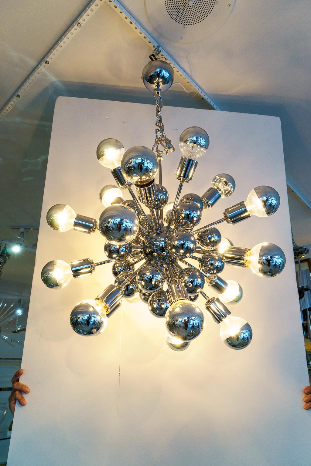 This stylish 20 light Sputnik style chandelier dates to the 1970s and was created by the italian architect and designer Giatano Scolari. 

Note: Dimensions not including the chain are 22