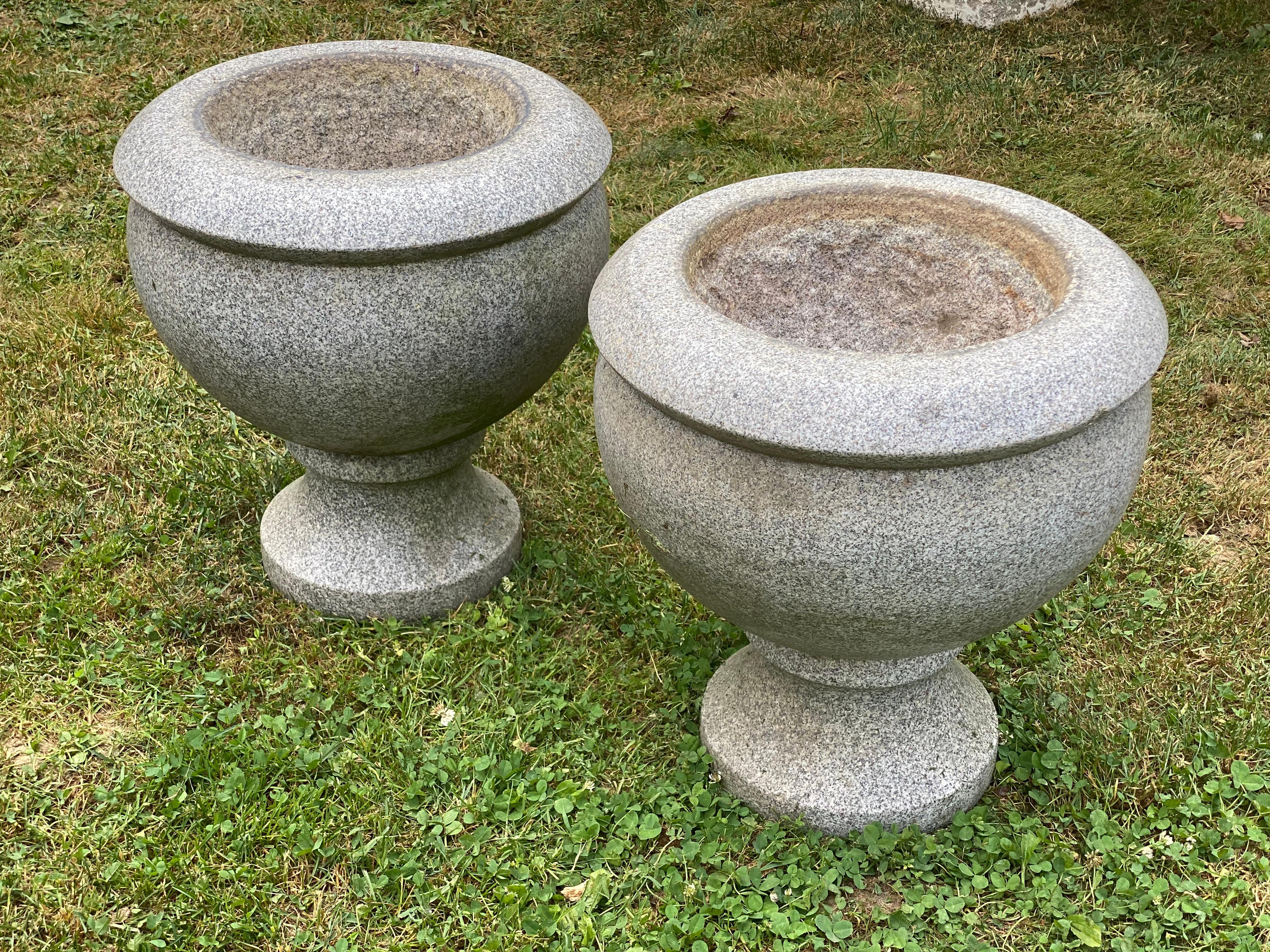 A wonderful pair of carved and polished monumental grey granite planters. These planters originated from a Westchester, NY estate overlooking Lower Hudson River. They were originally set atop columns with ferns cascading over their sides. A