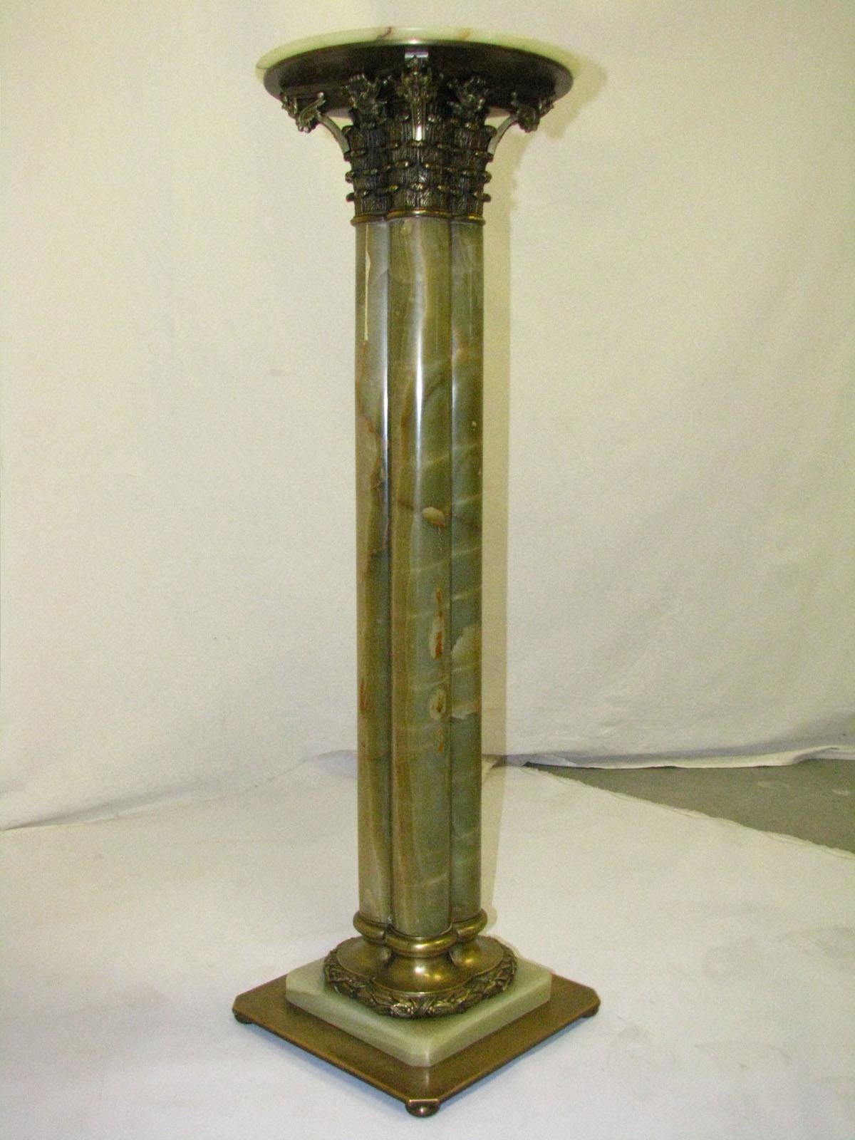 An unusual pedestal with an unusual height of almost one meter,
made of natural green onyx,
in the form of a column (consisting of 4 columns connected to each other with round smooth stems),
topped with a metal Corinthian and a stone