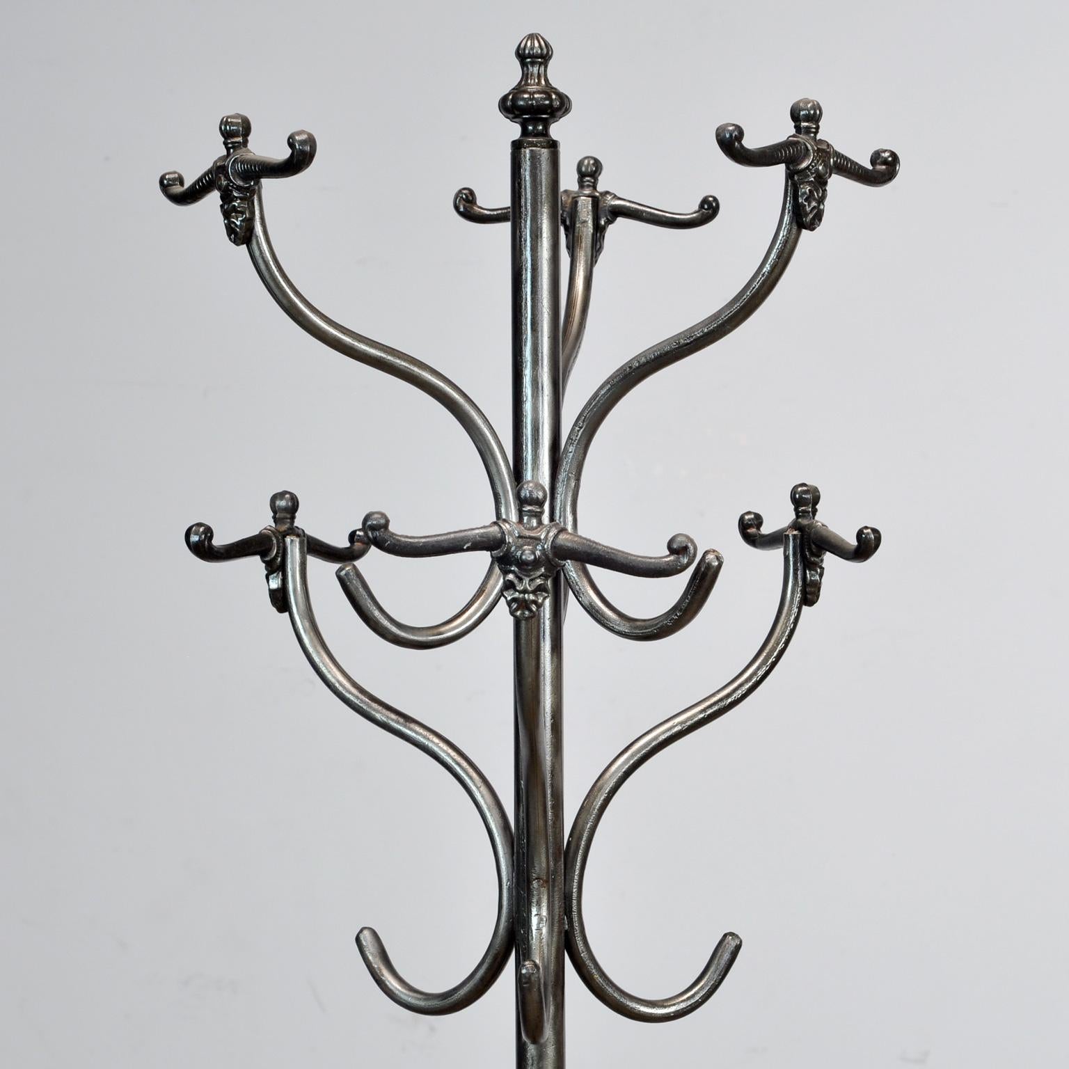 Polished iron coatrack with umbrella stand, circa 1920. With cast iron clothing hooks. Very nice condition.