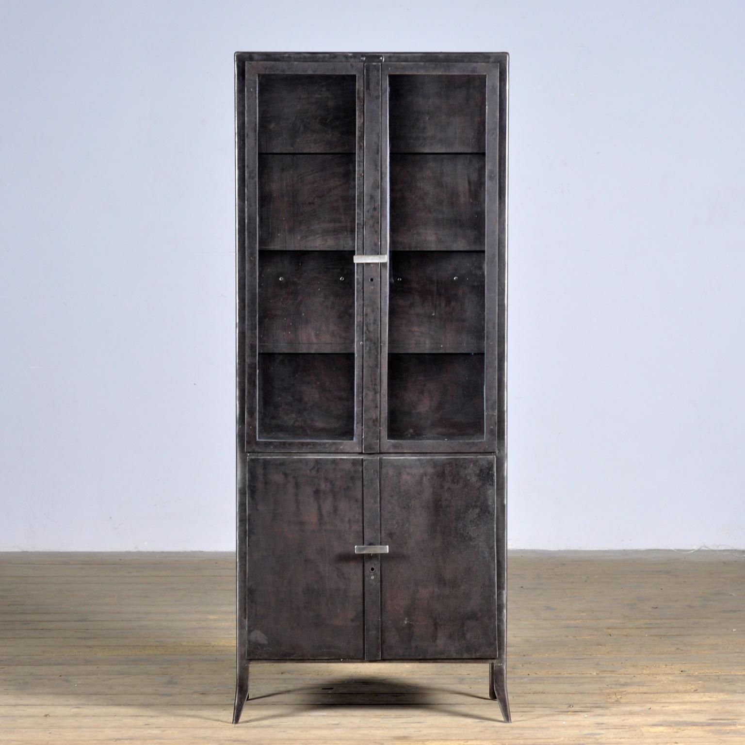 Medicine cabinet made of iron and glass. The cabinet is from the 1950s and was produced in Hungary. The cabinet is stripped down to the metal and finished with a transparent lacquer. The cabinet comes with 3 glass shelves.