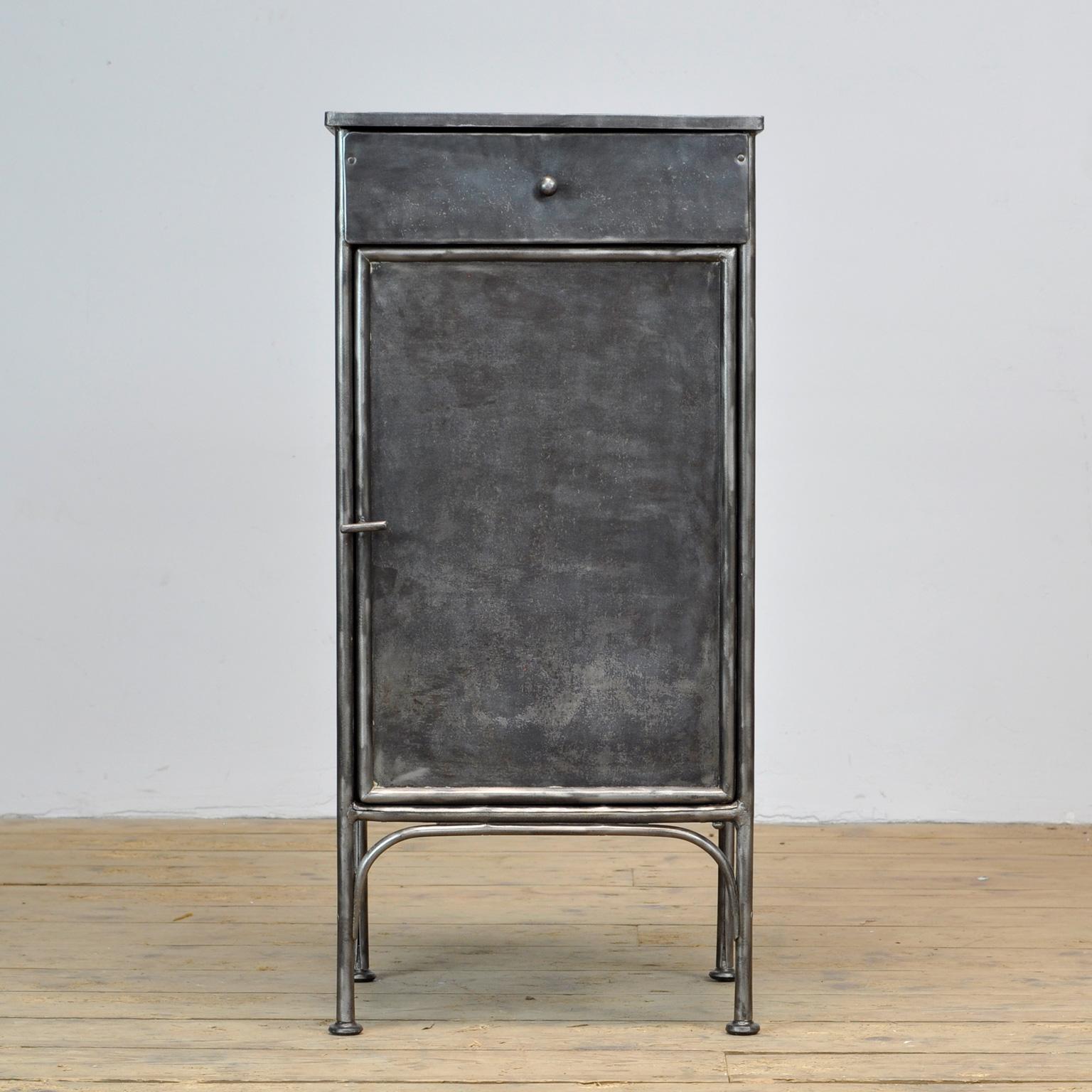 Polished iron hospital bedside cabinet. Produced in the 1910's.
 