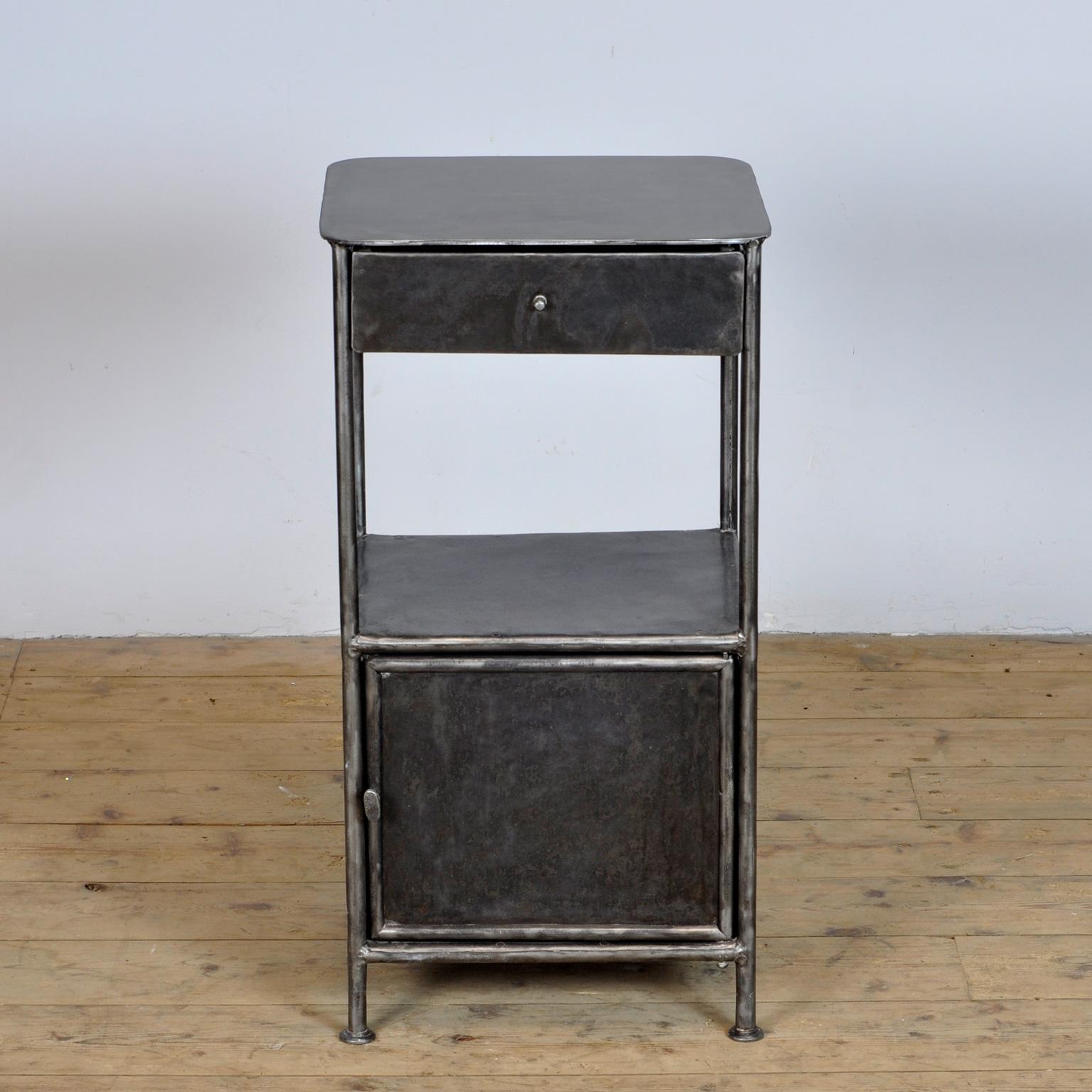 Polished iron hospital bedside cabinet. Produced in the 1910's in Germany.
     