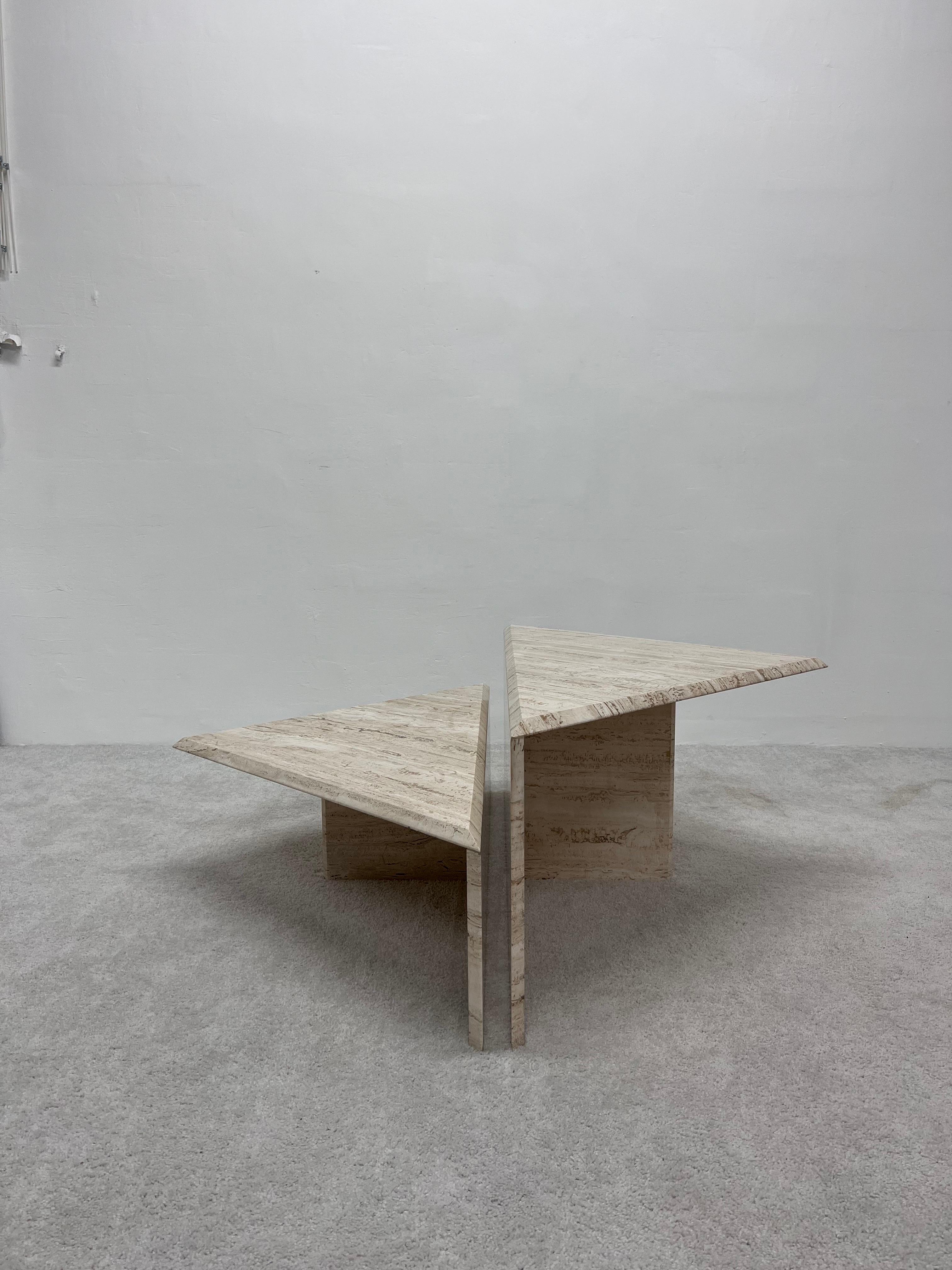 Two piece triangle polished Italian travertine marble coffee tables.

Dimensions:
Large 
W49-5/8” D25” H18-1/8”
Small
W49-5/8” D25” H12”.
