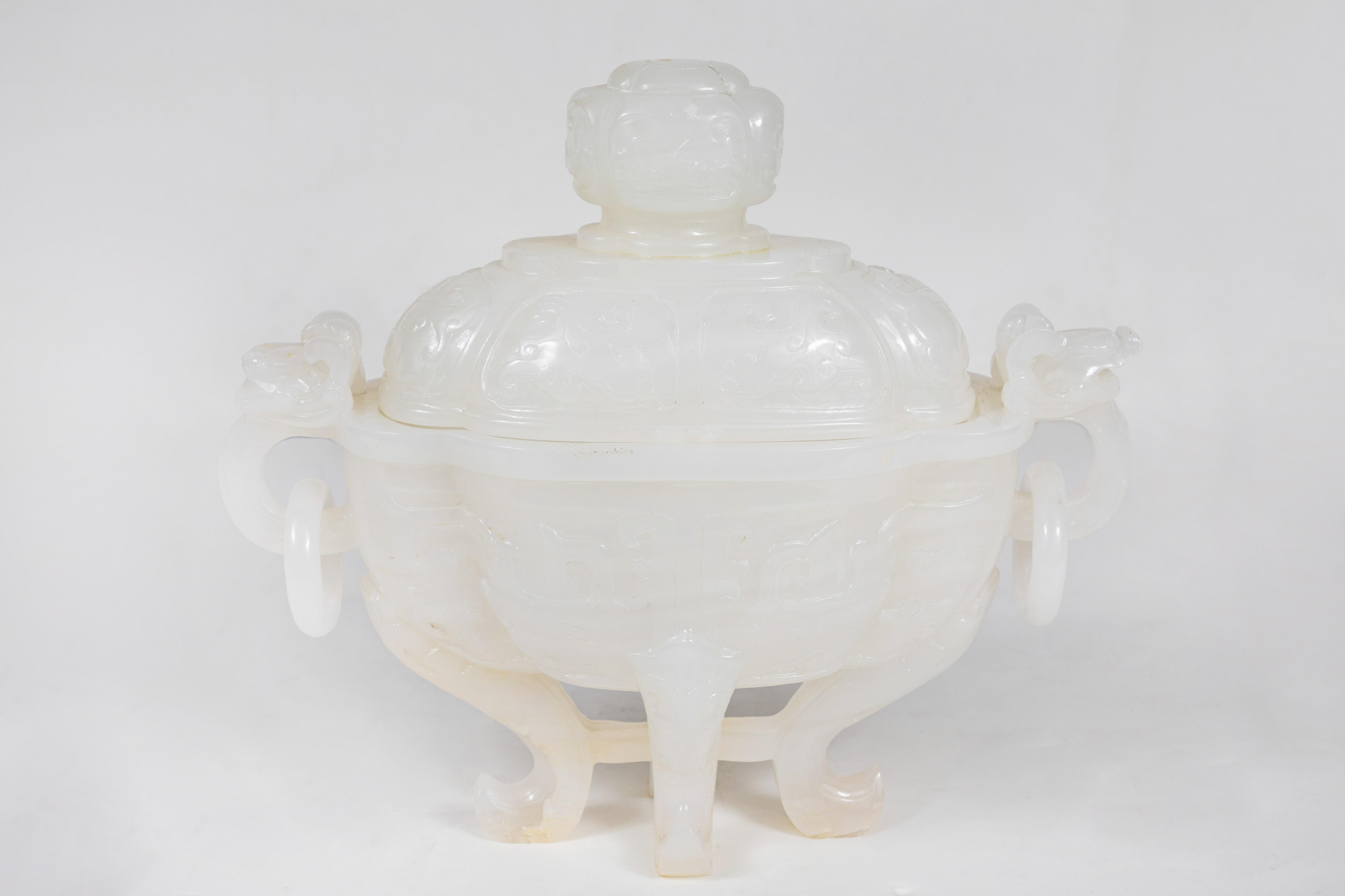 Elegant, relief-carved, polished, circa 1930, white-jade, lidded urn with pierced, dragon form handles atop scrolled feet.