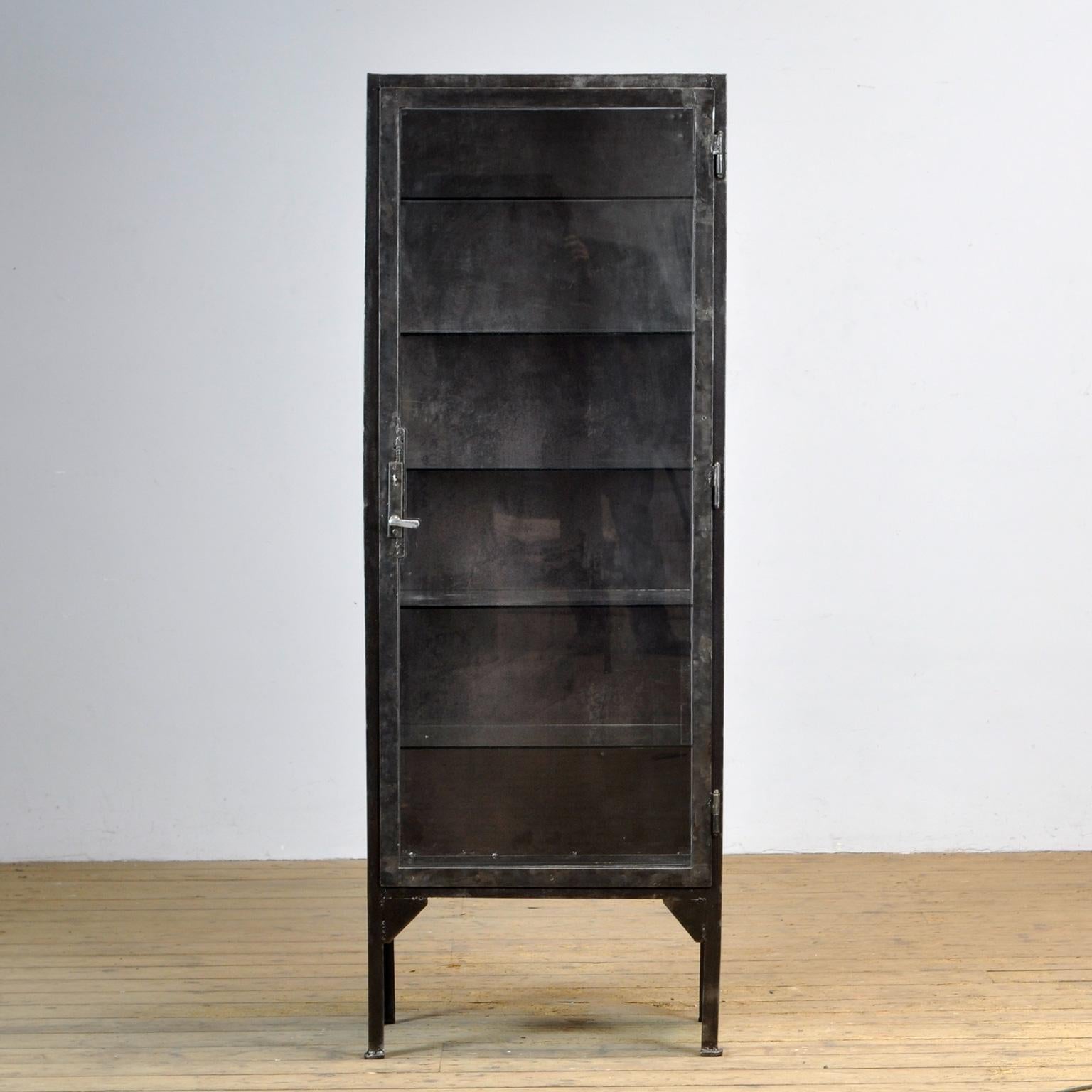 Medical cabinet from the 1930s. The cabinet is produced in Hungary and is made of thick iron and glass. The case has been stripped to the metal and treated against rust. With five glass shelves. The lock and handle are functional.