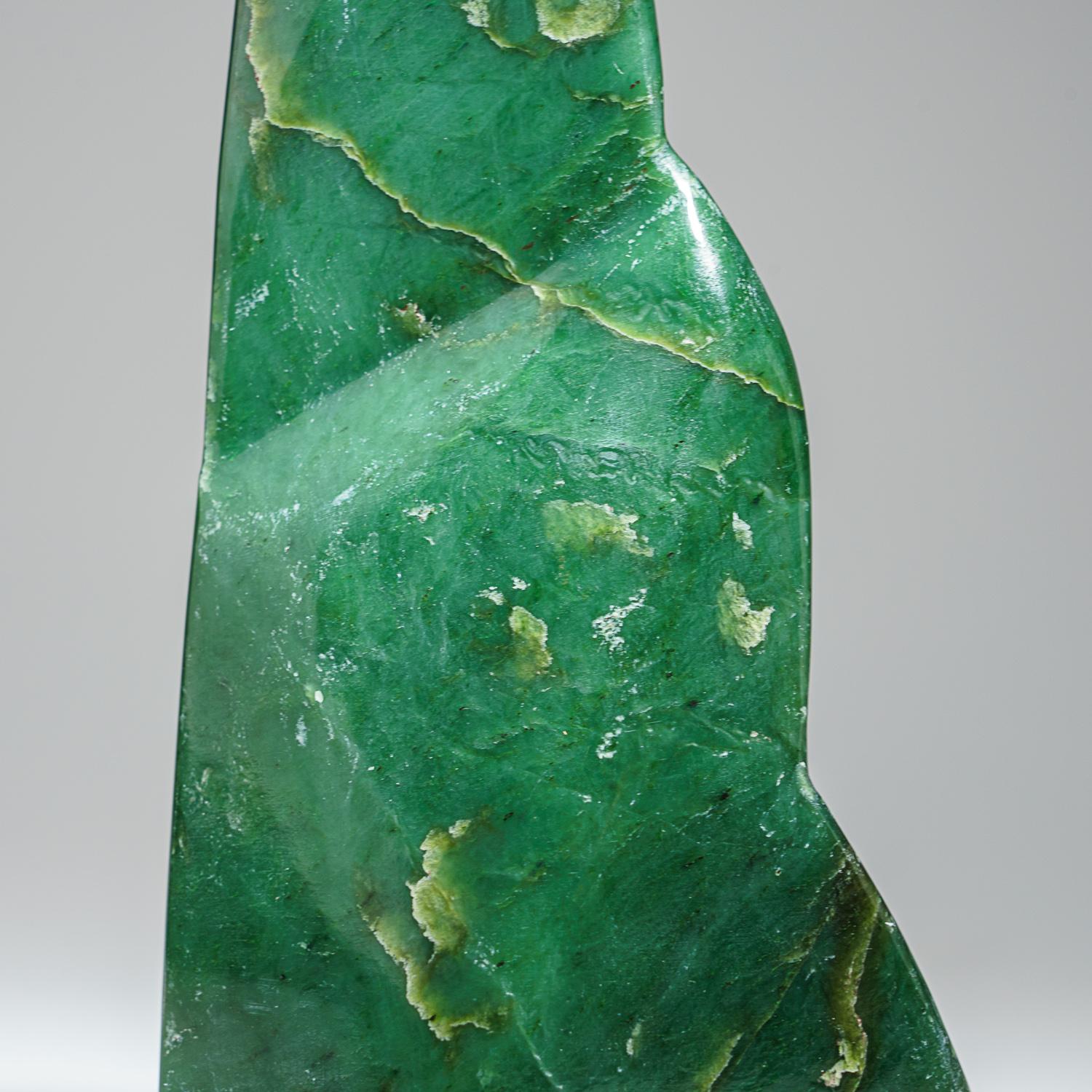 Stunning freeform carved from a solid piece of gem quality jade. This piece has a captivating color with a gleaming luster and beautiful transparencies. It has been hand polished to a mirrored finish. 

Known as the 