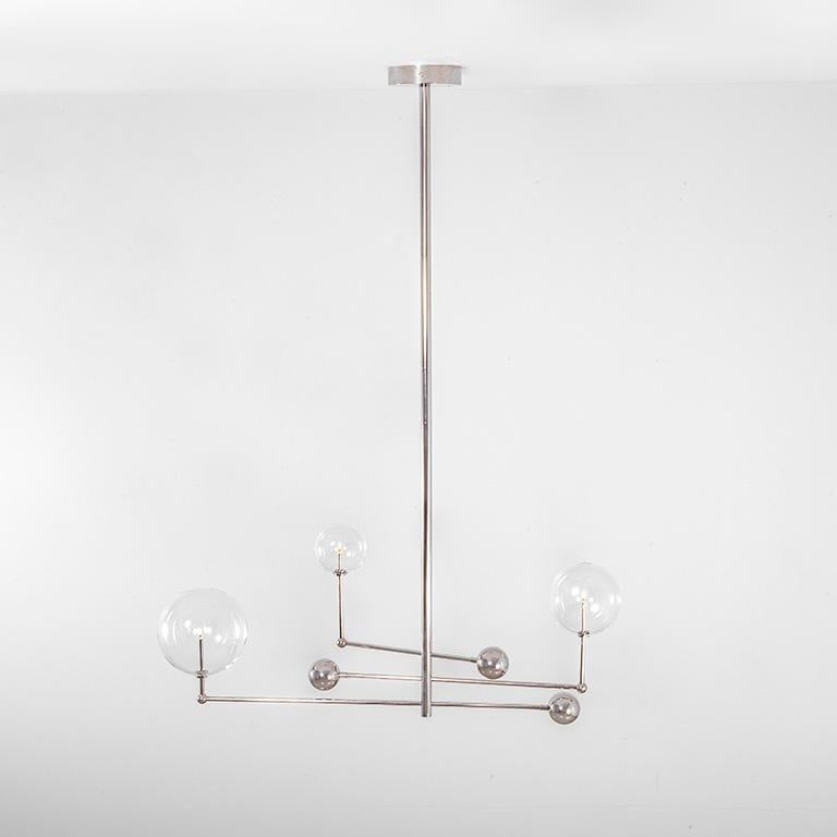 Polished nickel 3 arm Contemporary chandelier by Schwung 
Dimensions: D 25 x W 128.2 x H 178 cm 
Materials: solid brass, hand-blown glass globes.
Finish: polished nickel. 
Also available in finishes: black gunmetal or natural brass.
All our