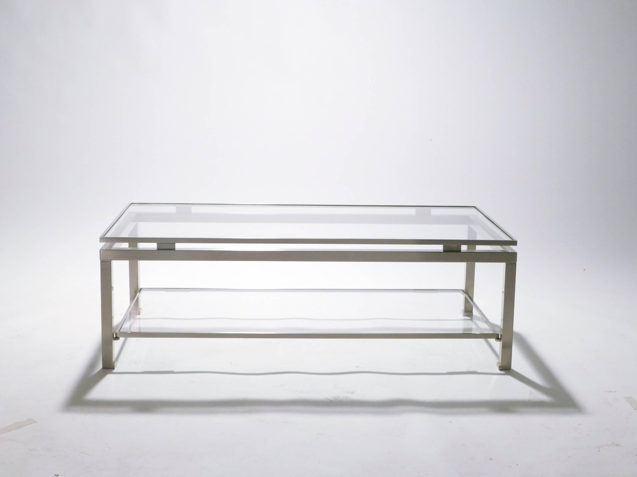 Subtly chic, this coffee table by Guy Lefevre for renowned Paris-based design firm Maison Jansen is slim and modern. Polished nickel makes up the feet of the table, lending a sophisticated and mid-century modern look to the piece, while 2/3