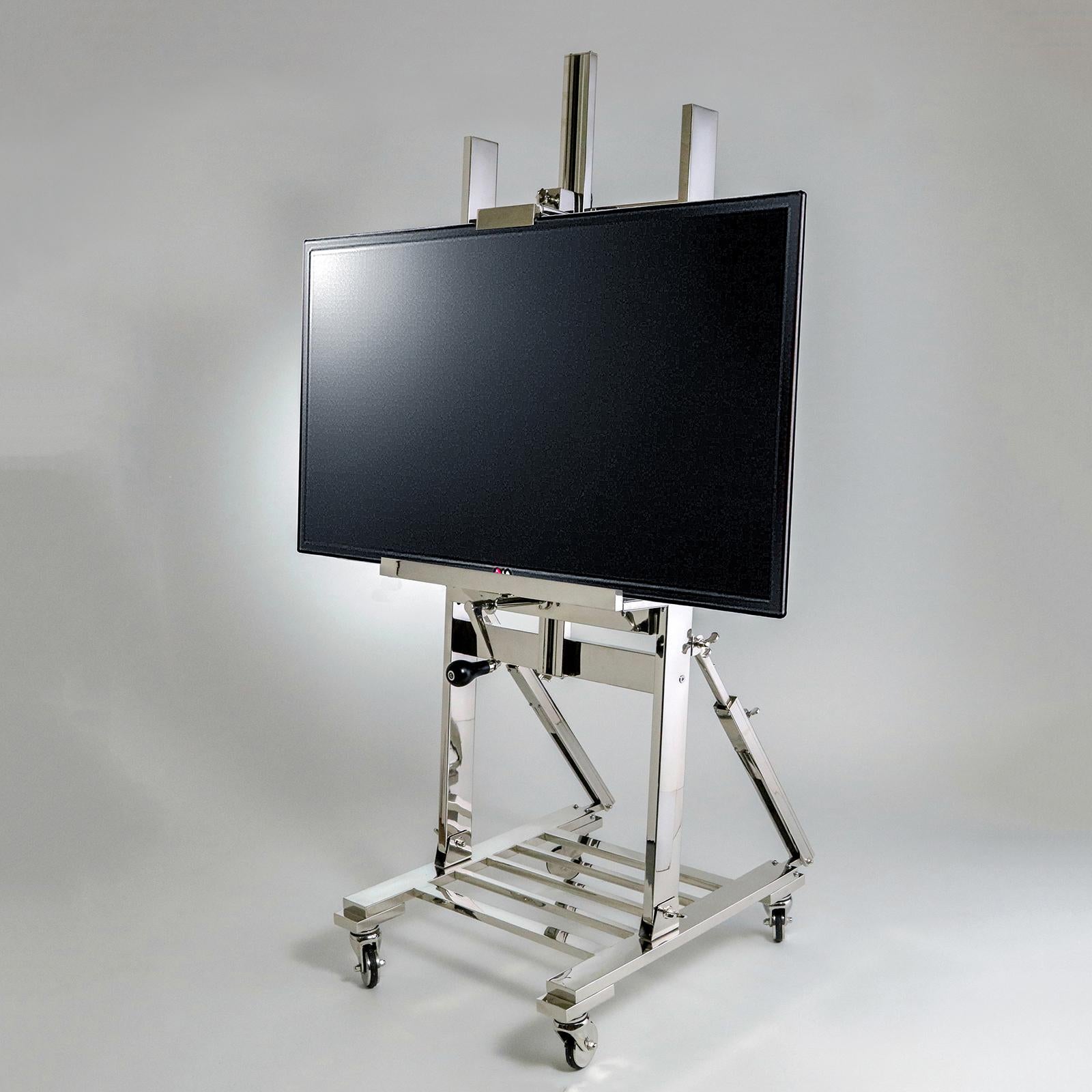 Large polished nickel adjustable TV stand/easel on casters. Hand crank adjusts flat screen height and angle. Slatted base accommodates cable box and/or DVD player.