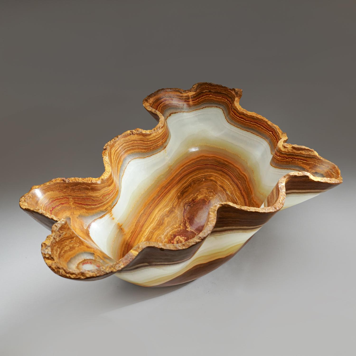 Genuine Polished Onyx Bowl From Mexico (30 lbs)

Large, one-of-a-kind, free-form natural onyx decorative bowl carved out of a single chunk of banded natural onyx. This incredible piece is polished to a mirror finish. This unique piece blends natural