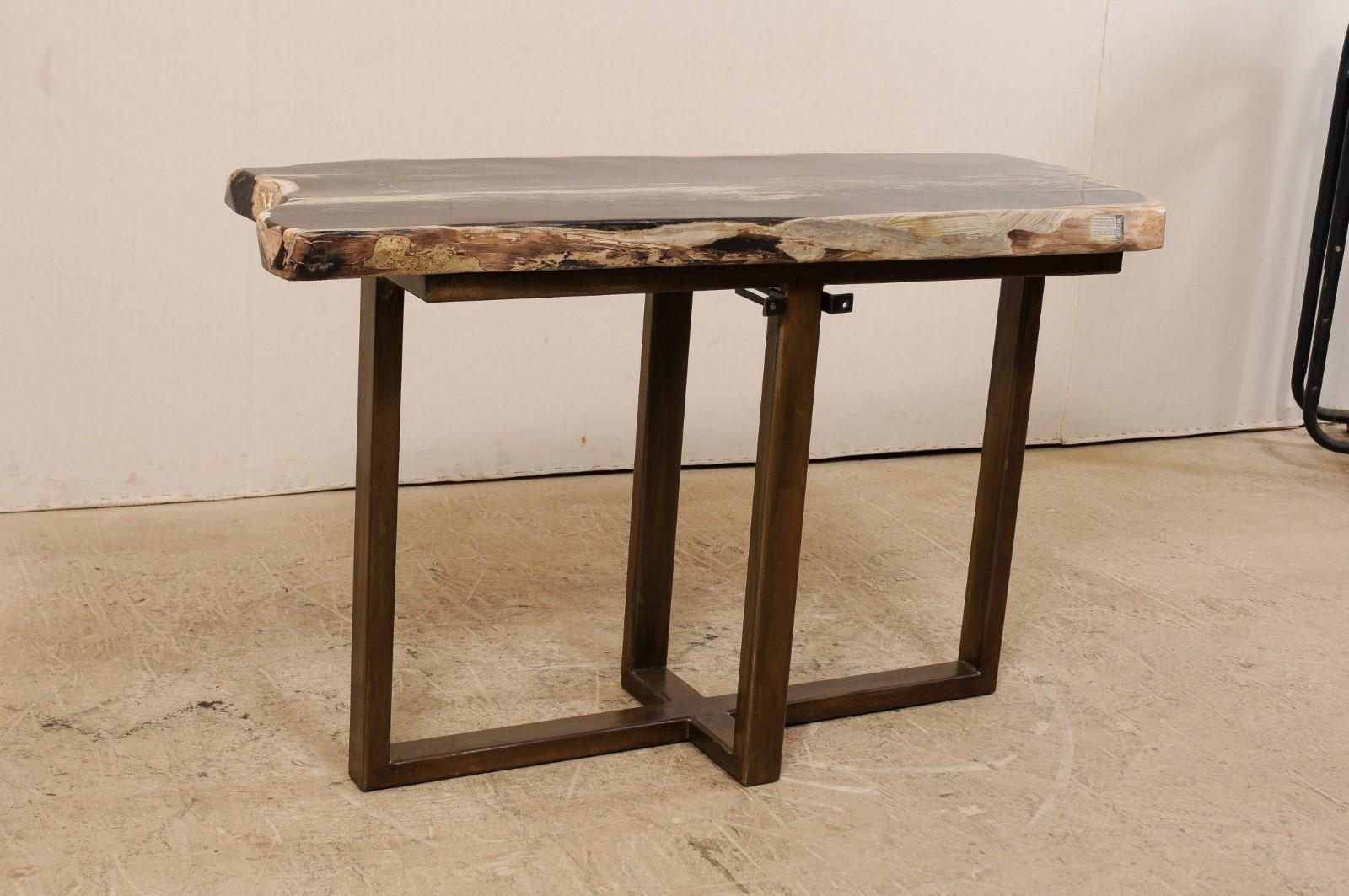 A petrified wood top modernly designed console table. This custom console table has been fashioned from a single thick slab of smoothly polished petrified wood, almost 4.5 feet in length. This fabulous petrified wood top is mostly black with shades