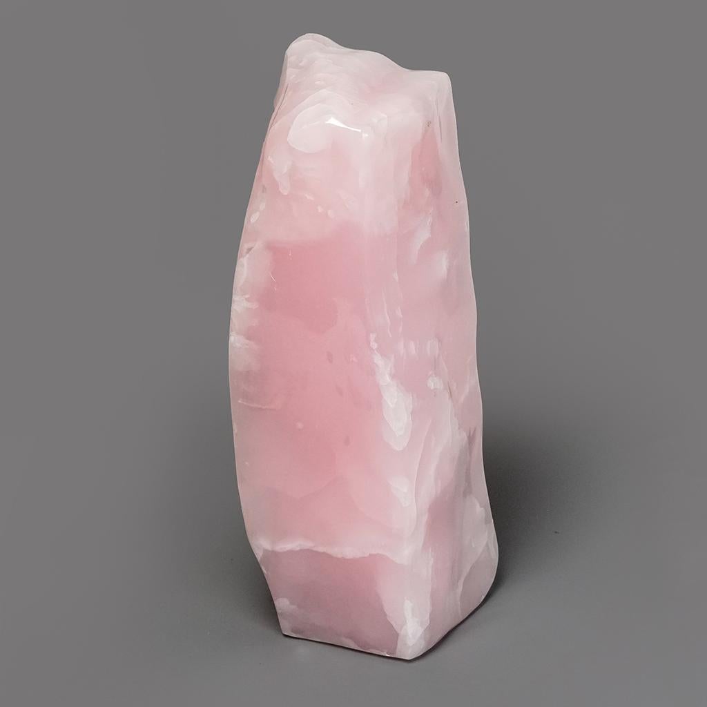 Hand polished freeform of banded pink mangano calcite from Pakistan. This specimen is very well defined with beautiful banded concentric patterns. This piece is solid material with no fill and is polished to a high-yield mirror finish.

Pink Mangano