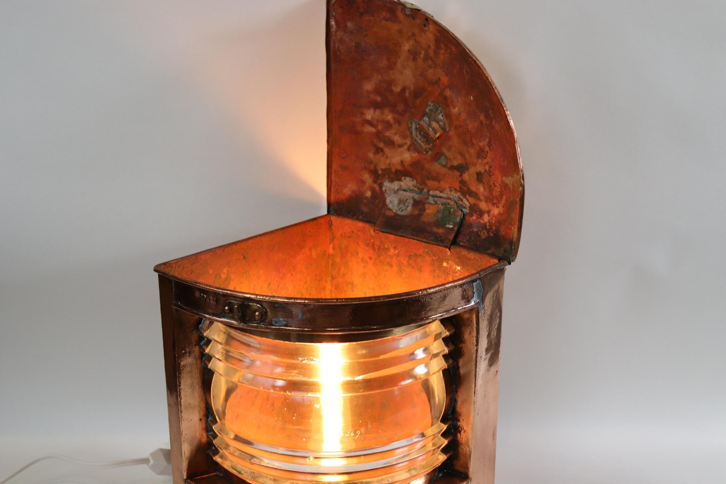Polished steel ships port lantern with red Fresnel lens, protective cage, sturdy carry handle, mounted to a thick wood base with dark rich finish. Lantern is wired with new socket and wire for home display. Weight is 15 pounds.