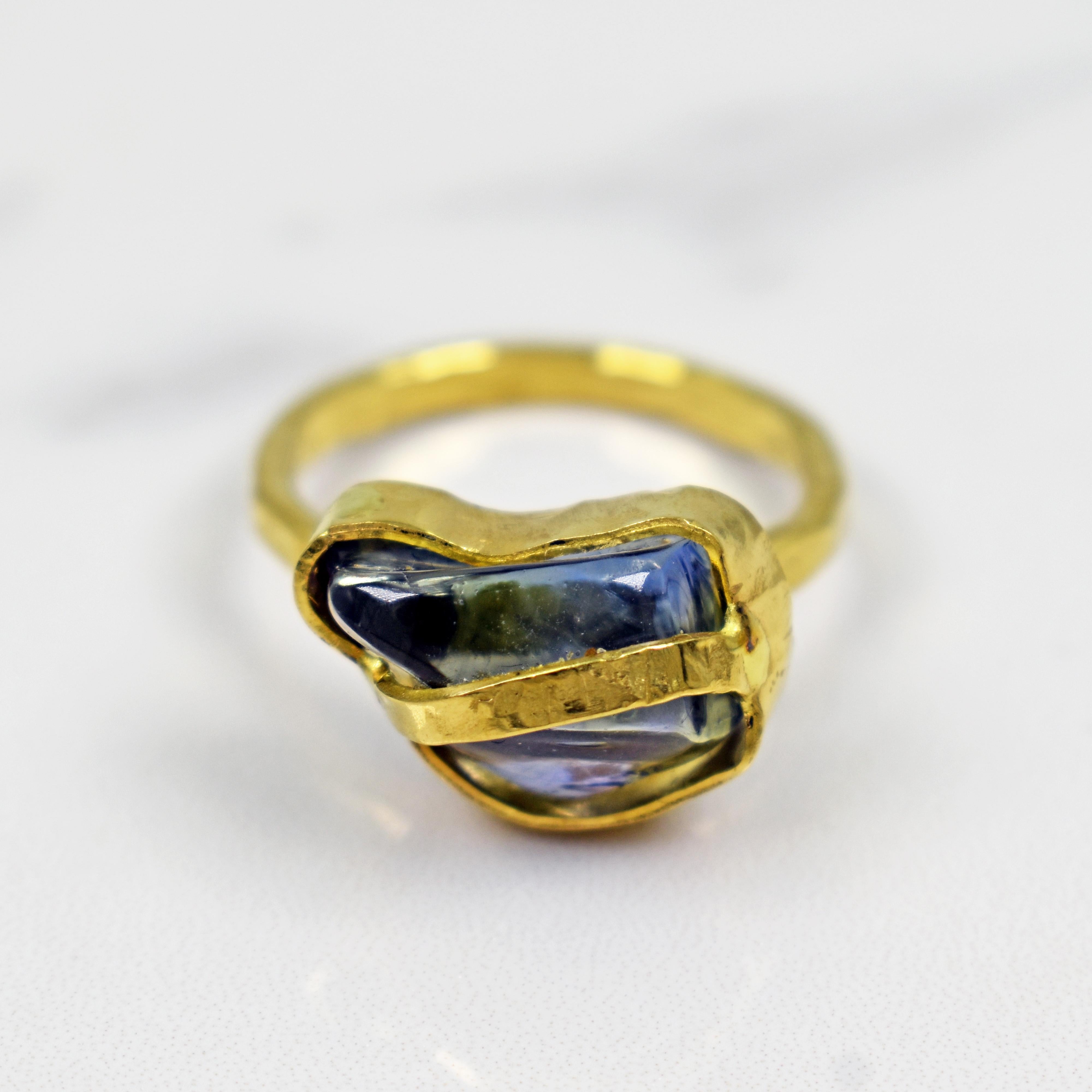 Unique, polished rough / freeform shaped blue Sapphire set in hammered, hand-forged 22k yellow gold fashion cocktail ring. Size 7. Gorgeous gemstone set in a one-of-a-kind, artisan ring with a rustic finish.