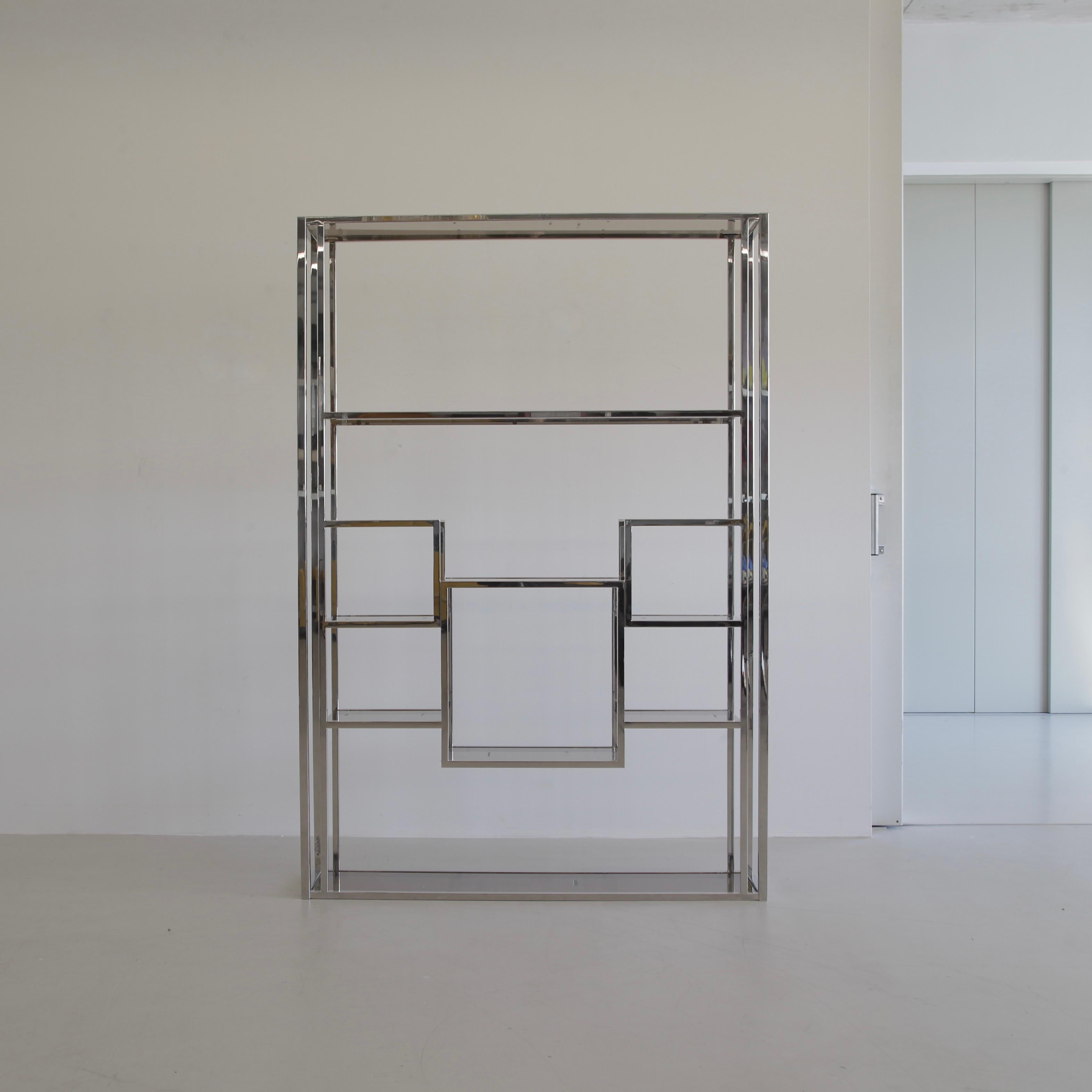 Library/ Room Divider, designed by Willy Rizzo. France, Willy Rizzo, 2012.

A large contemporary bookcase/ room divider made of polished stainless steel construction with smoked glass shelves on different levels. The frame has been signed by Willy