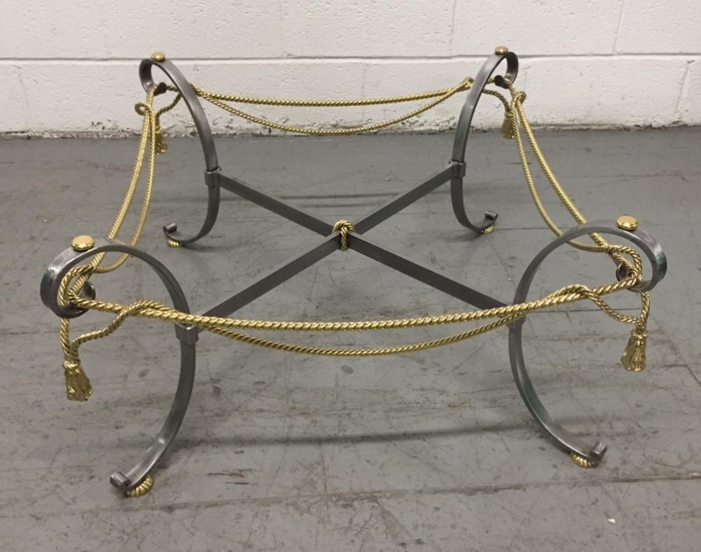Polished steel and brass coffee table in the style of Maison Jansen.