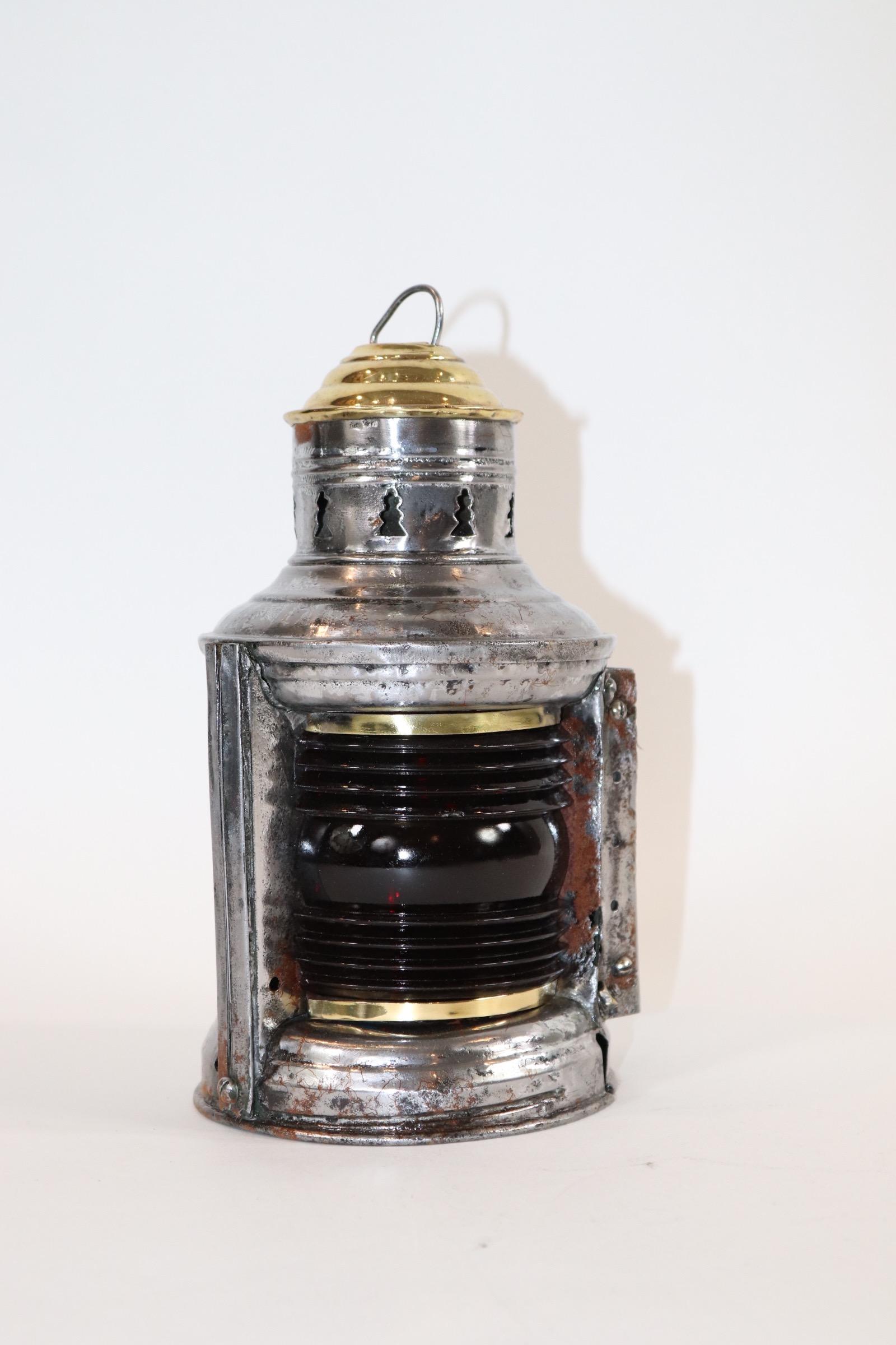 Polished steel marine bow lantern with port and starboard fresnel lenses, brass cap. Lacking its burner. Weight is 2 pounds.