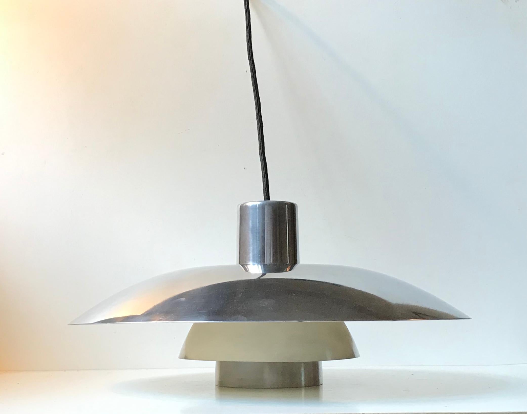 The PH 4/3 pendant light was designed in 1966 and this one is an example for this period. This light features its original porcelain fitting and outer shades in custom polished steel executed aftermarket rather nicely. The inner shades has its