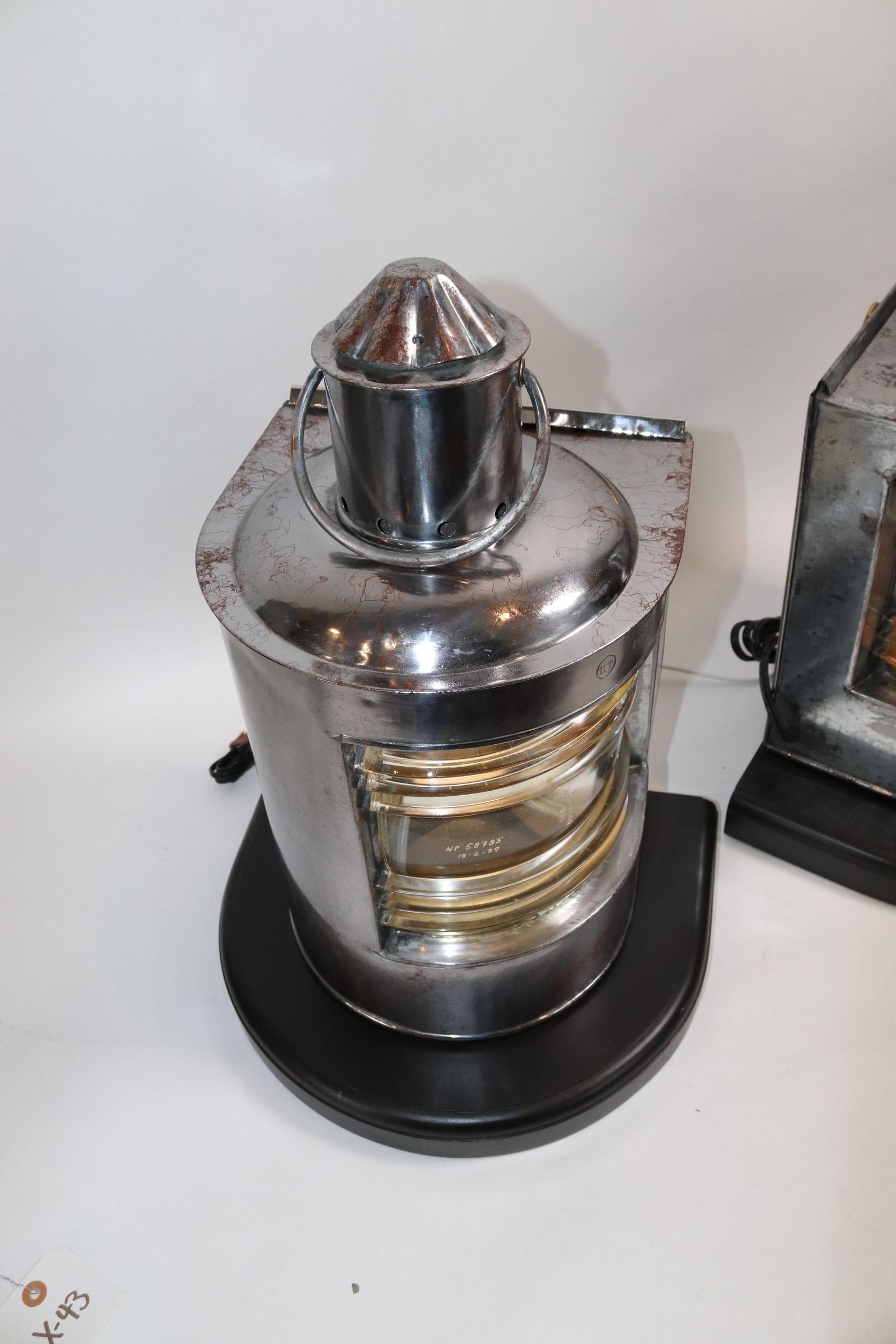 Pair of polished and lacquered ships port and starboard lanterns with clear glass Fresnel lenses, vented chimney tops, carry handles and sliding rear doors. Mounted to mahogany bases with routed edges and electrified for home display. Weight is 24