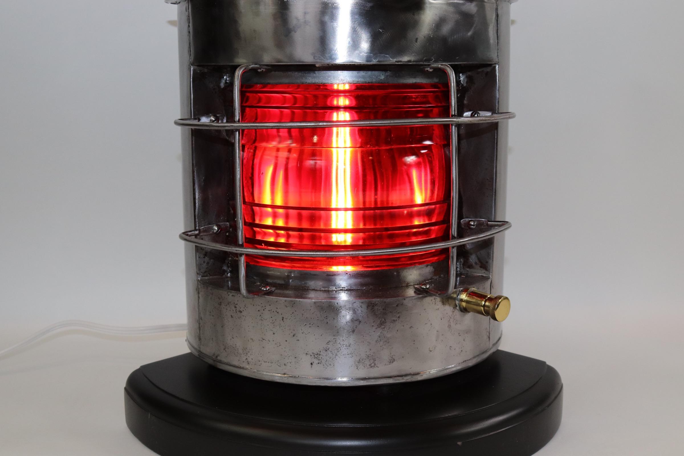 Polished steel ships port lantern with red Fresnel lens, protective cage, sturdy carry handle, mounted to a thick wood base with dark rich finish. Lantern is wired with new socket and wire for home display. Weight is 15 pounds.