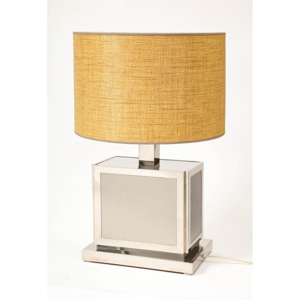 Polished Steel Table Lamp with Rattan Shade, by Liwan's Rome

This modern yet classic table lamp in beautiful chromed steel, with a raffia shade the sits atop a diffuser, was manufactured by Liwan's, Rome. The small manufacturer is known for their