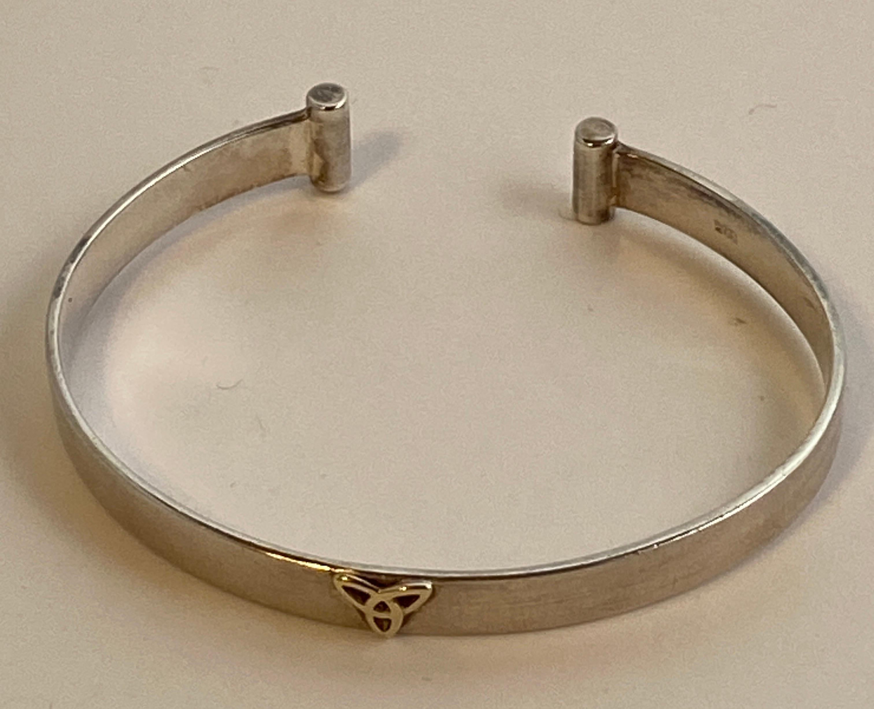 Wonderfully fine detailed polished sterling silver cuff bracelet accented with 14k yellow gold on the center of the cuff measures 6 1/4 inches in length. The width measures 3/8 of an inch. Made in The US.