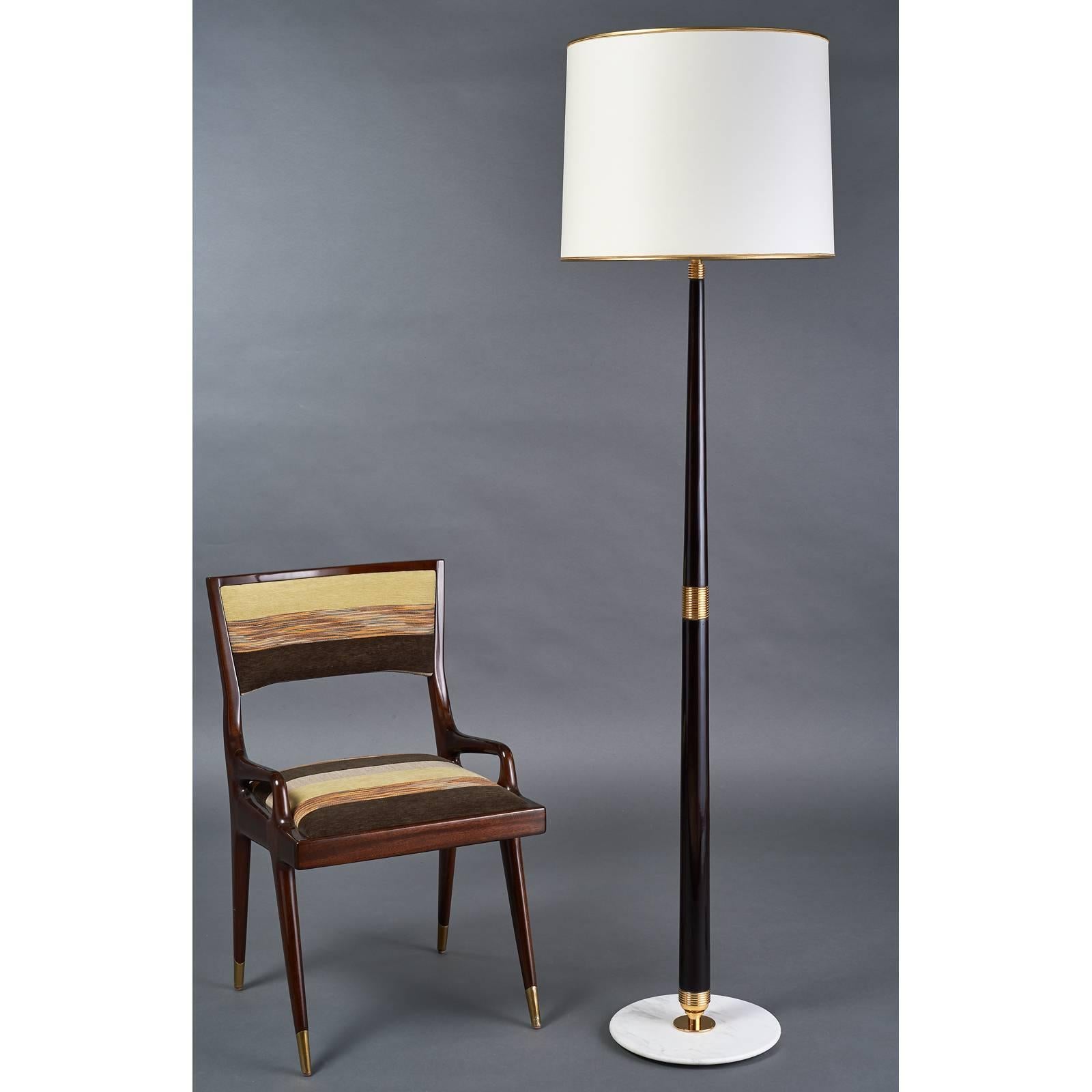Elegant polished mahogany stained wood floor lamp in the manner of Stilnovo,
with tapering shaft and polished ribbed brass mounts,
beveled marble base. Italy, 1950s
Measures: 70 H x 18.5 diameter
Rewired for use in the USA with three standard base