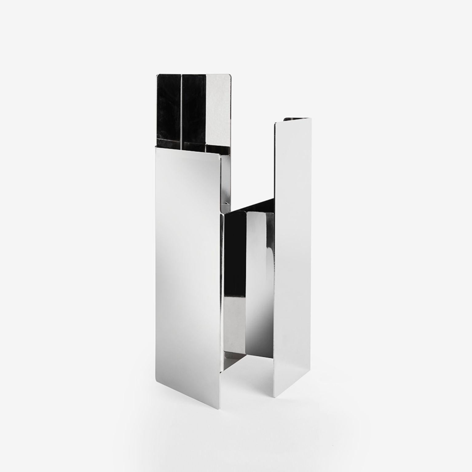 Polished white nickel fugit vase by Mason Editions
Design: Matteo Fiorini
Dimensions: 12 × 15 × 34 cm
Materials: Iron, pirex glass

Fugit vase consists of a metal sheet that seems to turn and close around itself, generating an alternation of