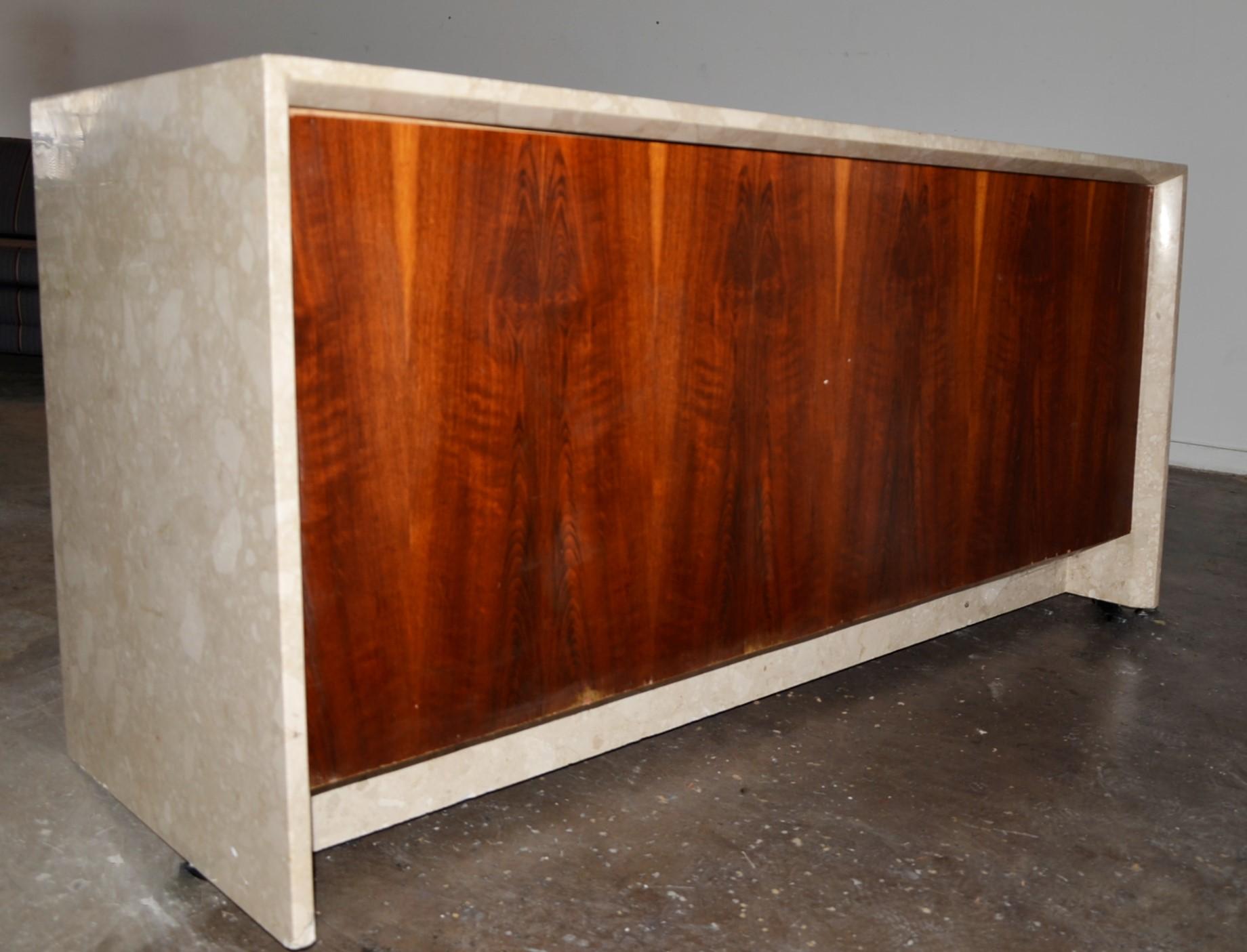 Offered is a Mid-Century Modern gracious polished tan and creamy white. travertine marble cantilevered sideboard with an inset (what is thought to be) brown rosewood cabinet that is finished on all four sides. Perfect for any 