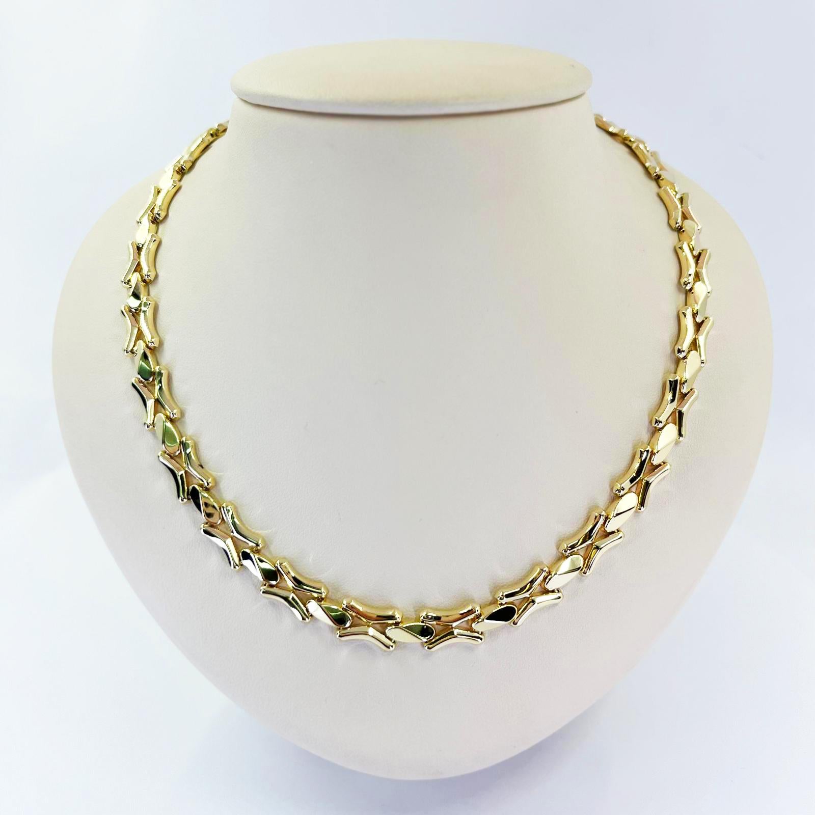 14 karat yellow gold polished link necklace featuring angled design. 17 inches long with hidden box clasp and figure 8 safety. Finished weight is 26.0 grams.