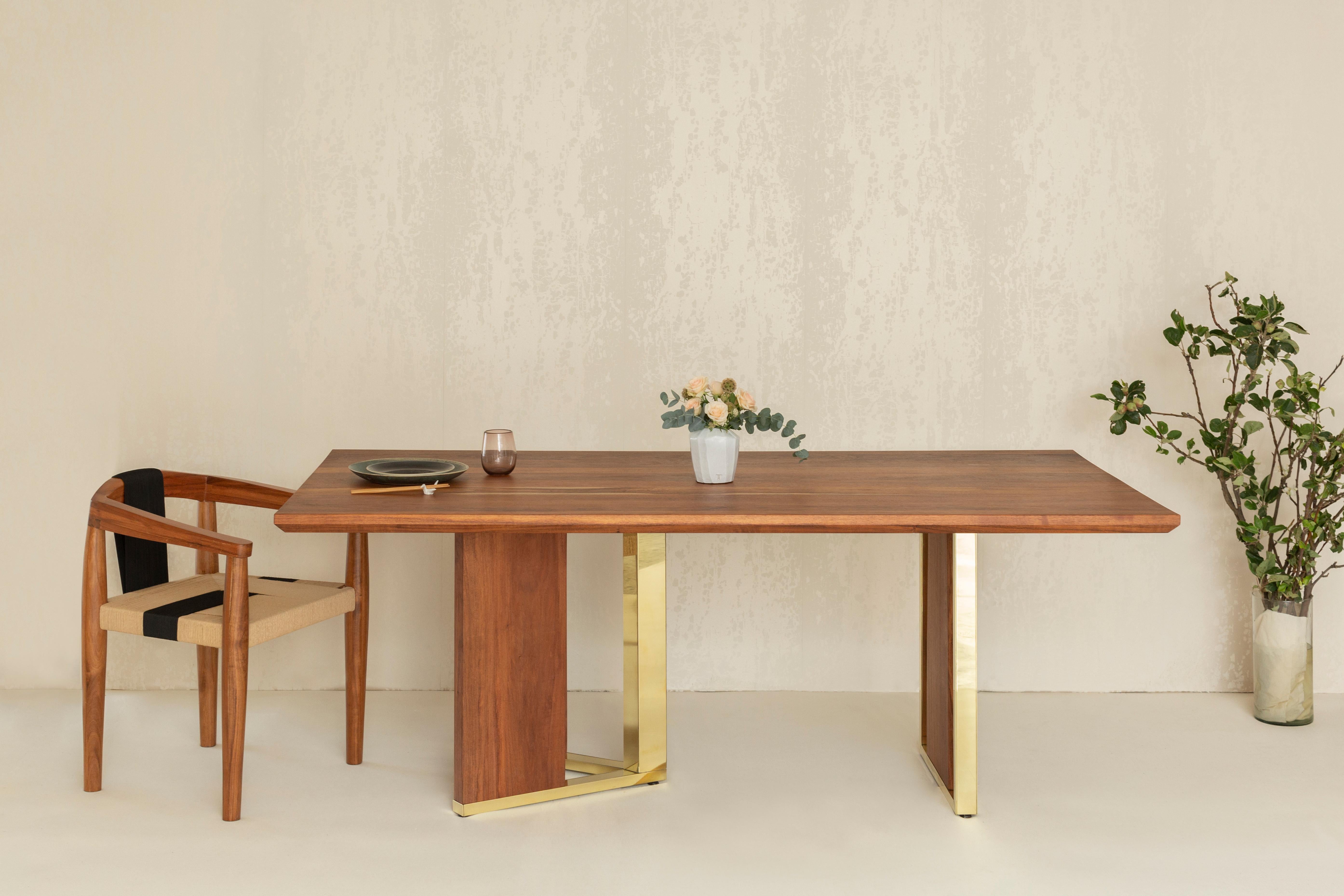 The Pollan table is a made out of a Mexican wood calles Tzalam. It serves as a dining table or can be used as a desk. The legs are a unique combination of brass and wood.