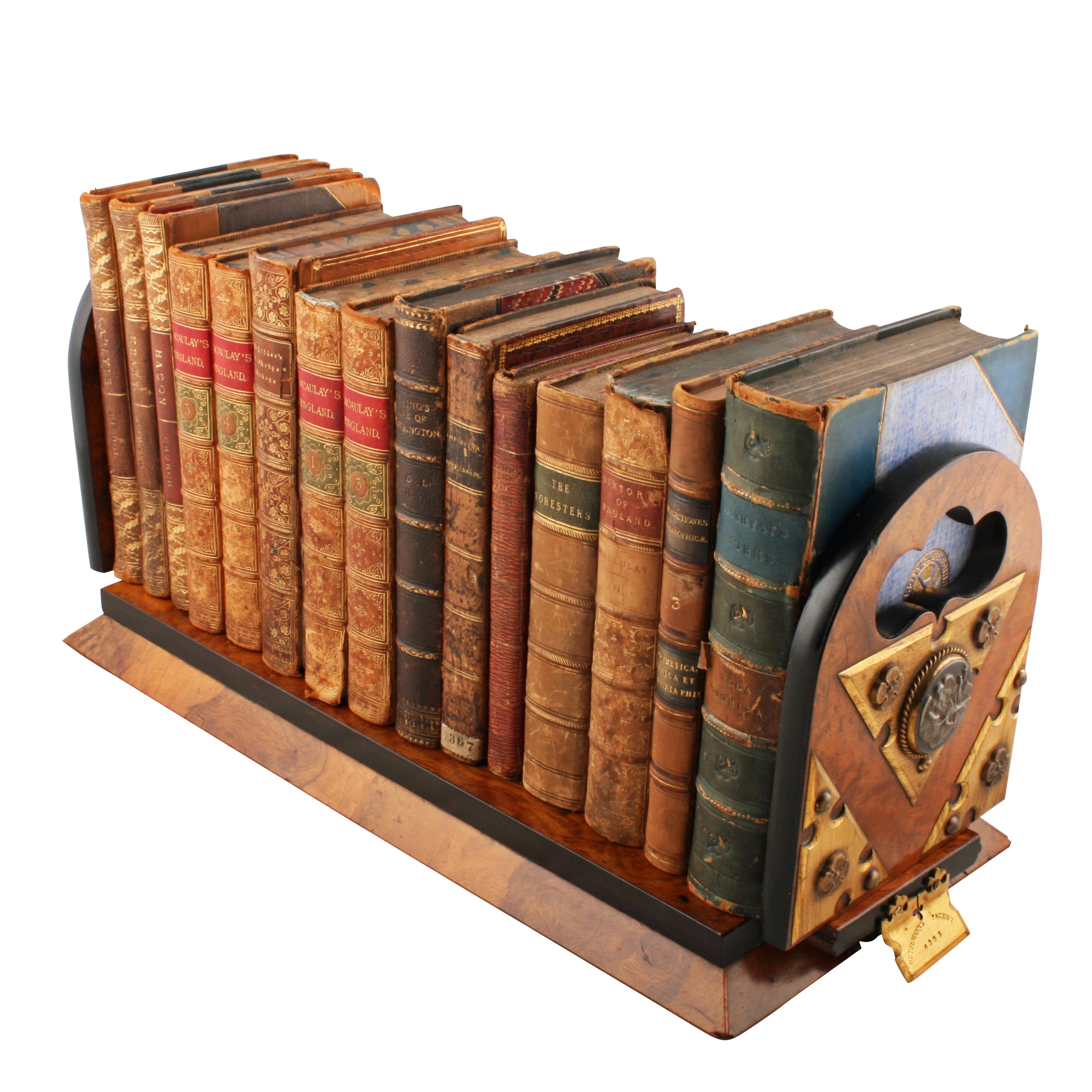 A Victorian pollard oak veneered Betjemann's patent adjustable book slide.

The book slide has folding flaps at each end that slide open to hold more books and have shaped carrying hand grips at the top and gilt brass mounts.

The book slide has