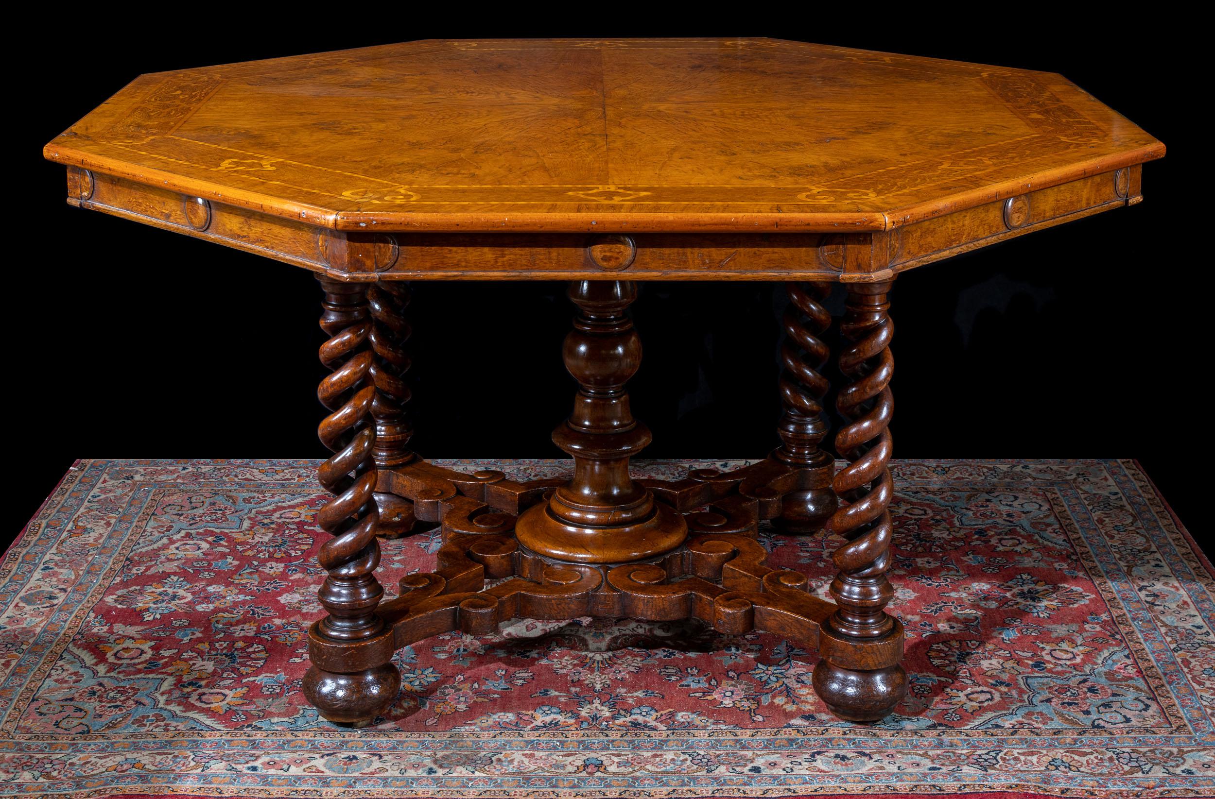 A superb octagonal centre table in the manner of Thomas King. The fine octagonal top in book matched pollard oak veneer, inlaid with a satinwood border, on a pit sawn oak top. This rests on four spiral twist legs joined by scrolling stretchers and