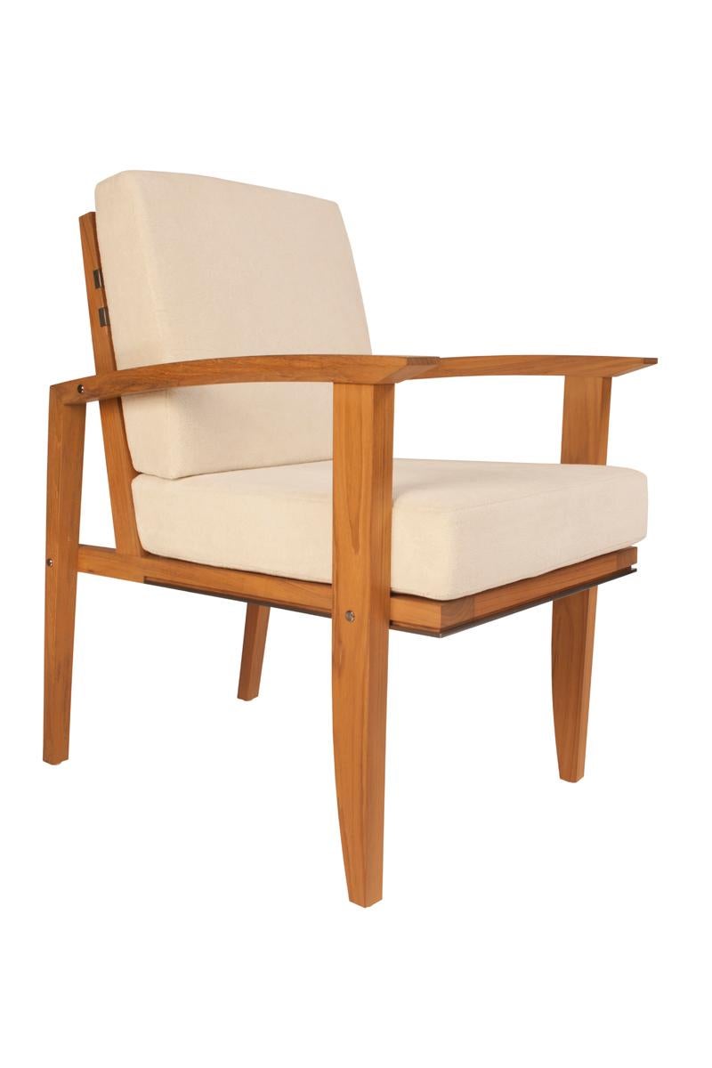 Designed to withstand the elements beautifully. An exterior dining armchair handmade by Pollaro master craftsmen and engineered to provide appropriate seat height, firmness, arm height, and lumbar support for dining. Of hand-selected Burmese teak
