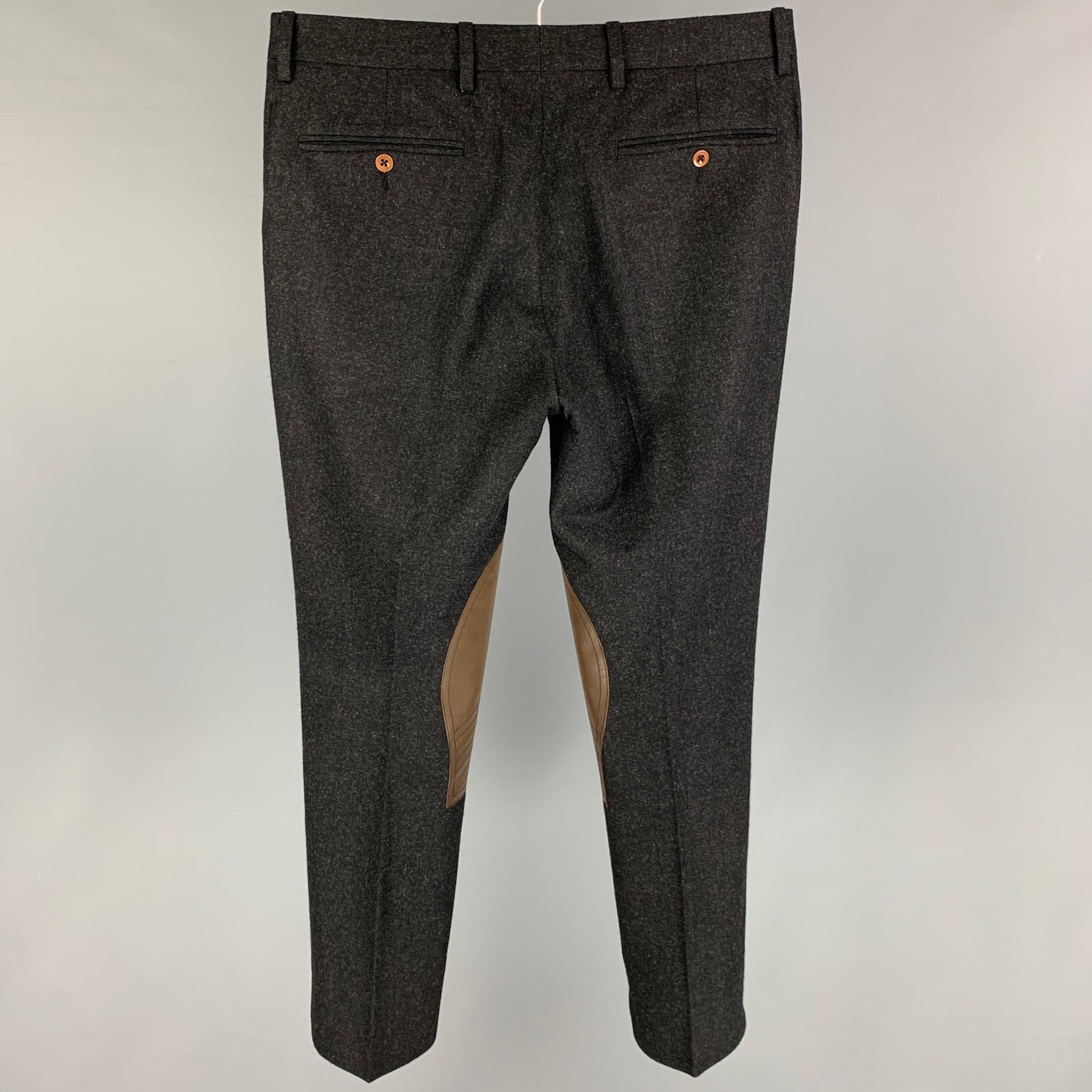 POLO by POLO RALPH LAUREN dress pants comes in a charcoal wool featuring brown leather patch details, slim fit, and a zip fly closure. 

Very Good Pre-Owned Condition.
Marked: 30

Measurements:

Waist: 32 in.
Rise: 9.5 in.
Inseam: 29 in. 