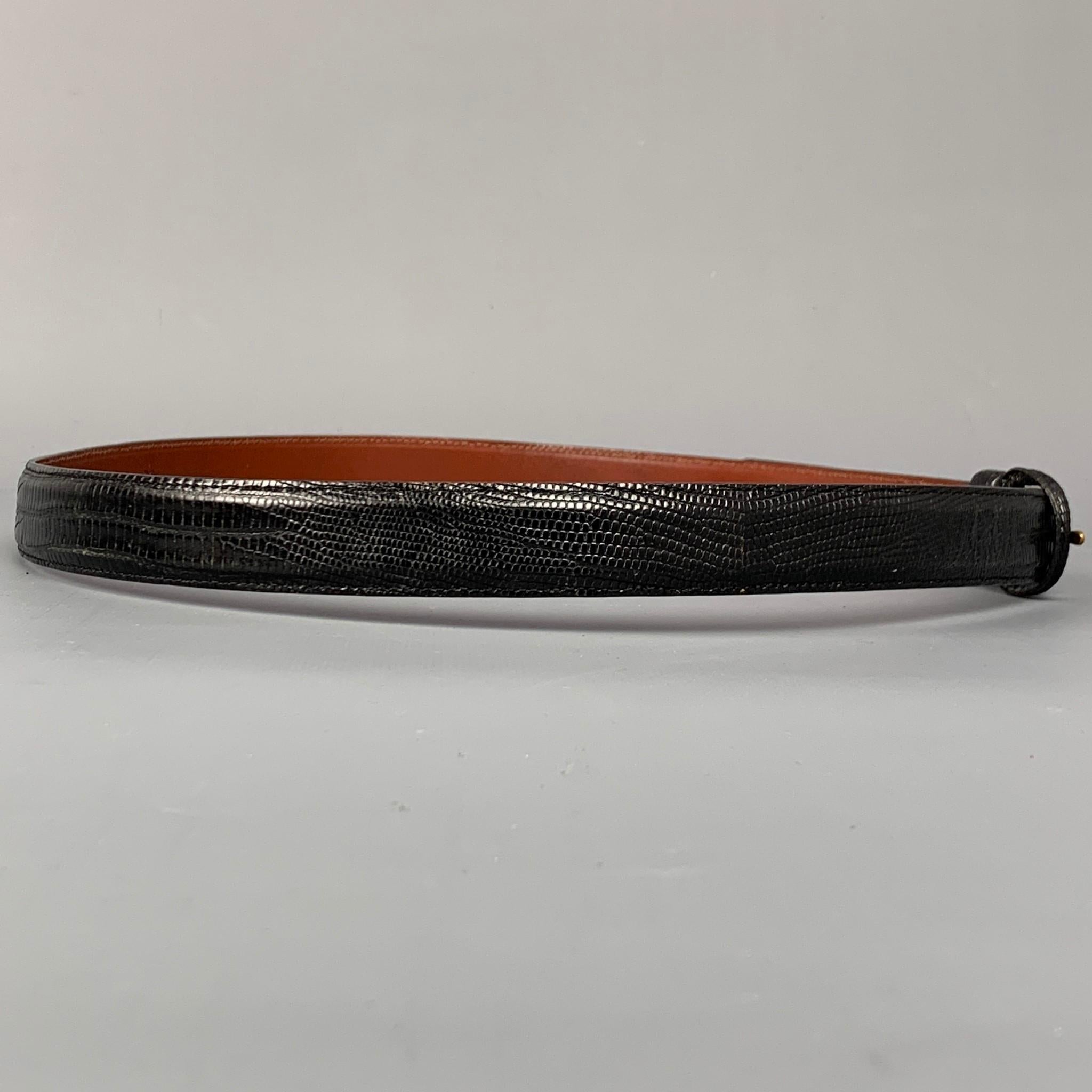 POLO by RALPH LAUREN belt comes in a black lizard leather featuring a covered buckle closure. Made in USA.

Very Good Pre-Owned Condition.
Marked: 36

Length: 41 in.
Width: 0.75 in.
Fits: 34 in. - 38 in.
 