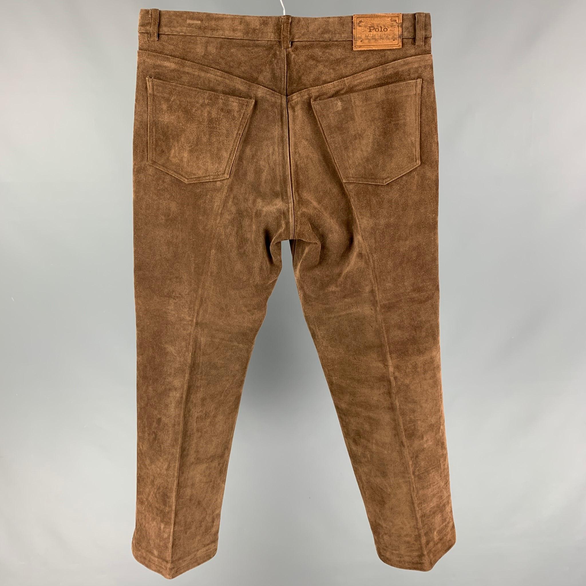 POLO by RALPH LAUREN pants comes in a brown suede featuring a straight leg and a zip fly closure. 

Good Pre-Owned Condition.
Marked: 38

Measurements:

Waist: 36 in.
Rise: 12 in.
Inseam: 29 in. 