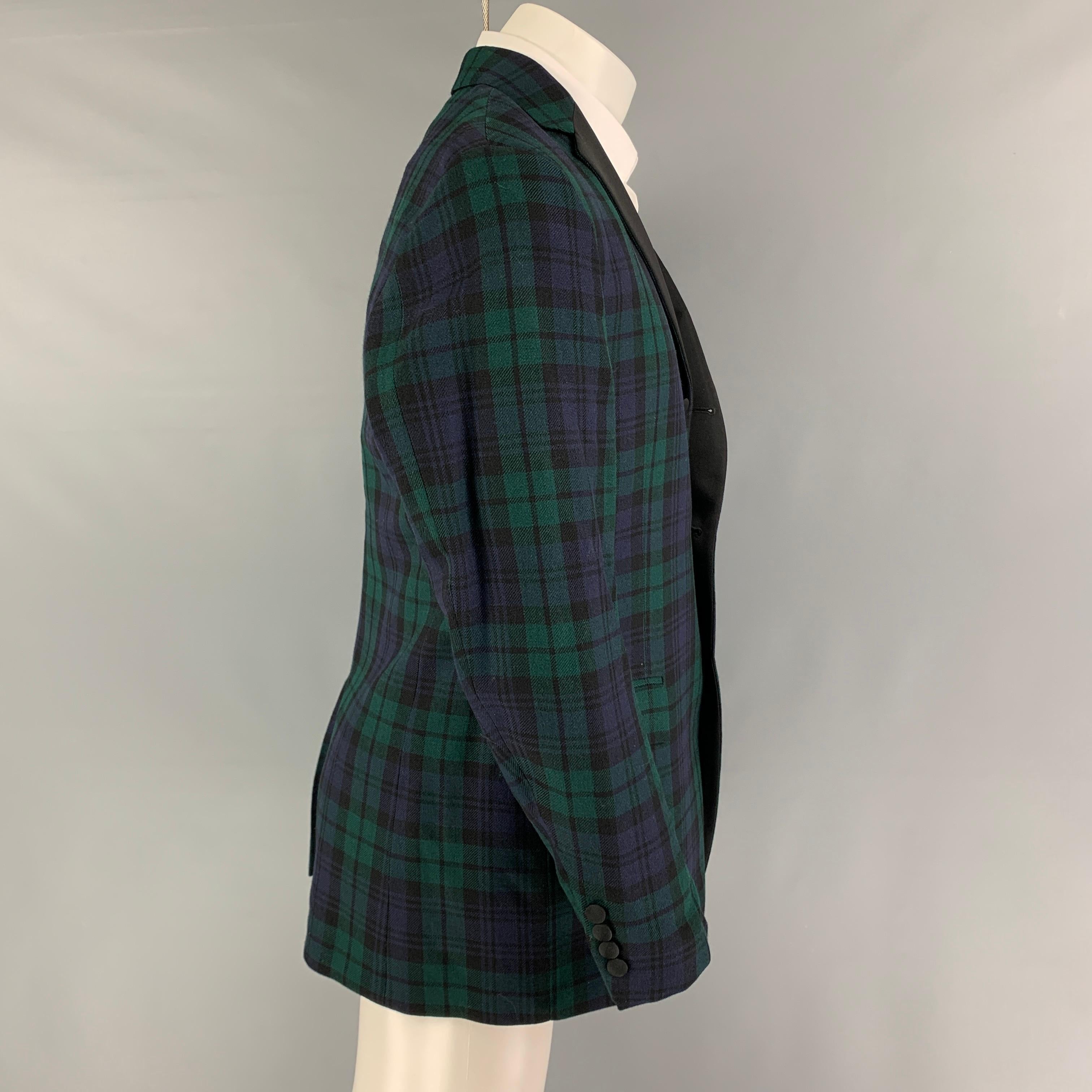 POLO by RALPH LAUREN sport coat comes in a blackwatch plaid wool with a full liner featuring a notch lapel, flap pockets, single back vent, and a three button closure. Made in Italy.

Very Good Pre-Owned Condition.
Marked: