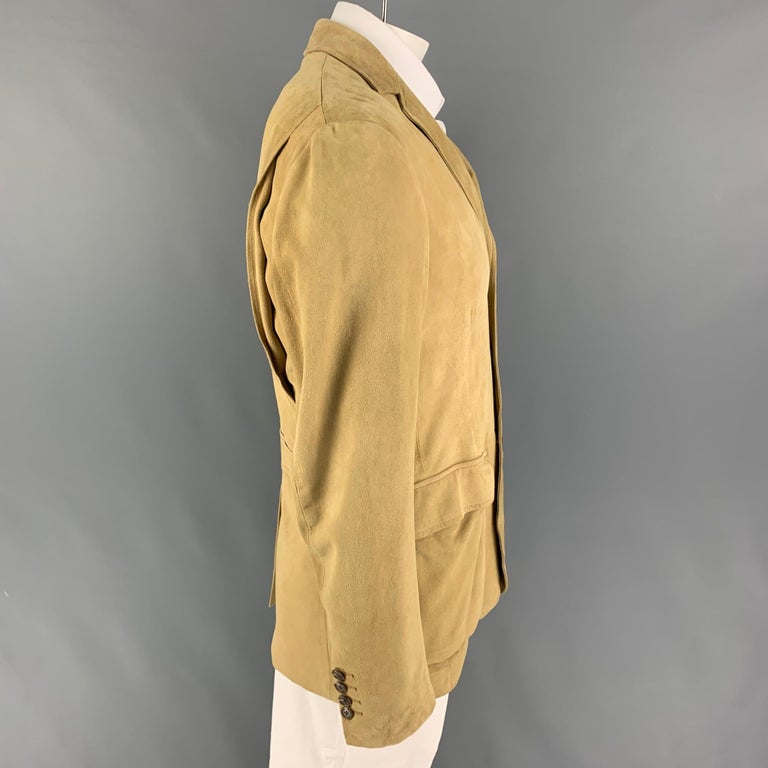 POLO by RALPH LAUREN sport coat comes in a khaki suede with a full liner featuring a notch lapel, flap pockets, single back vent, and a three button closure. 

Very Good Pre-Owned Condition.
Marked: 42 R

Measurements:

Shoulder: 19.5 in.
Chest: 42