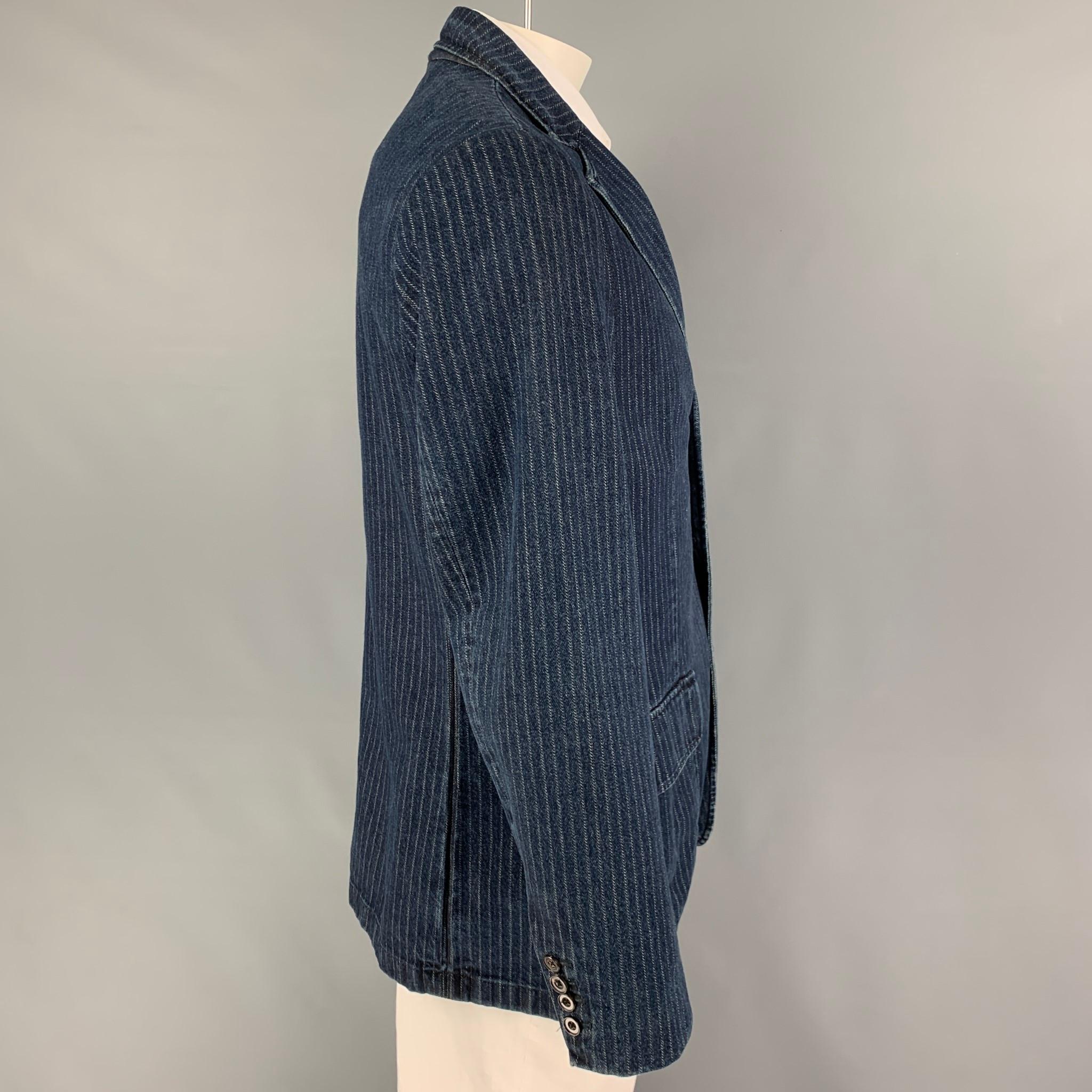 POLO by RALPH LAUREN sport coat comes in a indigo pinstripe cotton with a half liner featuring a a notch lapel, flap pockets,single back vent, and a three button closure. Made in Italy.

Very Good Pre-Owned Condition.
Marked: