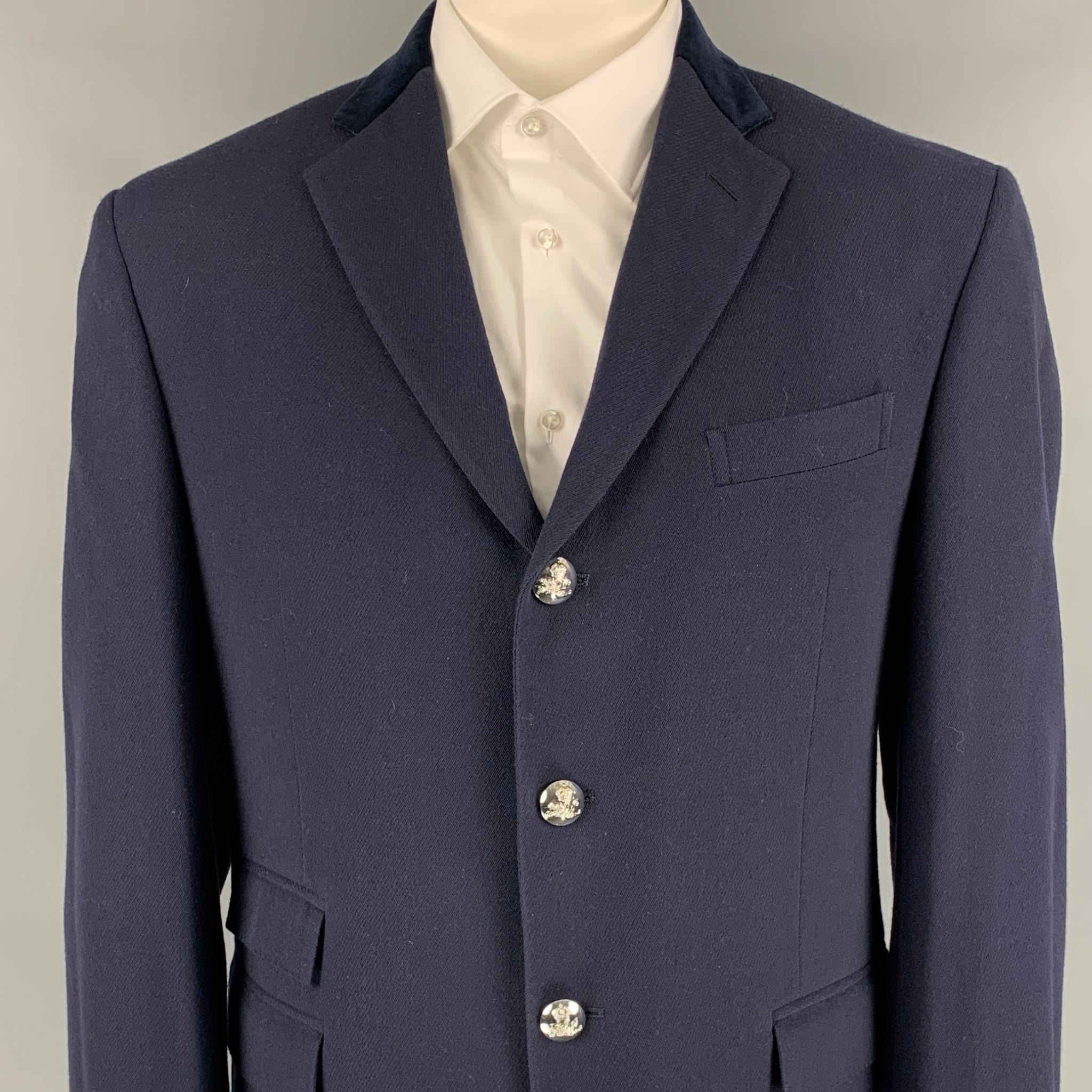 POLO by RALPH LAUREN sport coat comes in a navy virgin wool with a full liner featuring a velvet notch lapel, flap pockets, double back vent, and a silver tone buttoned closure. 

Very Good Pre-Owned Condition.
Marked: 44 R

Measurements:

Shoulder: