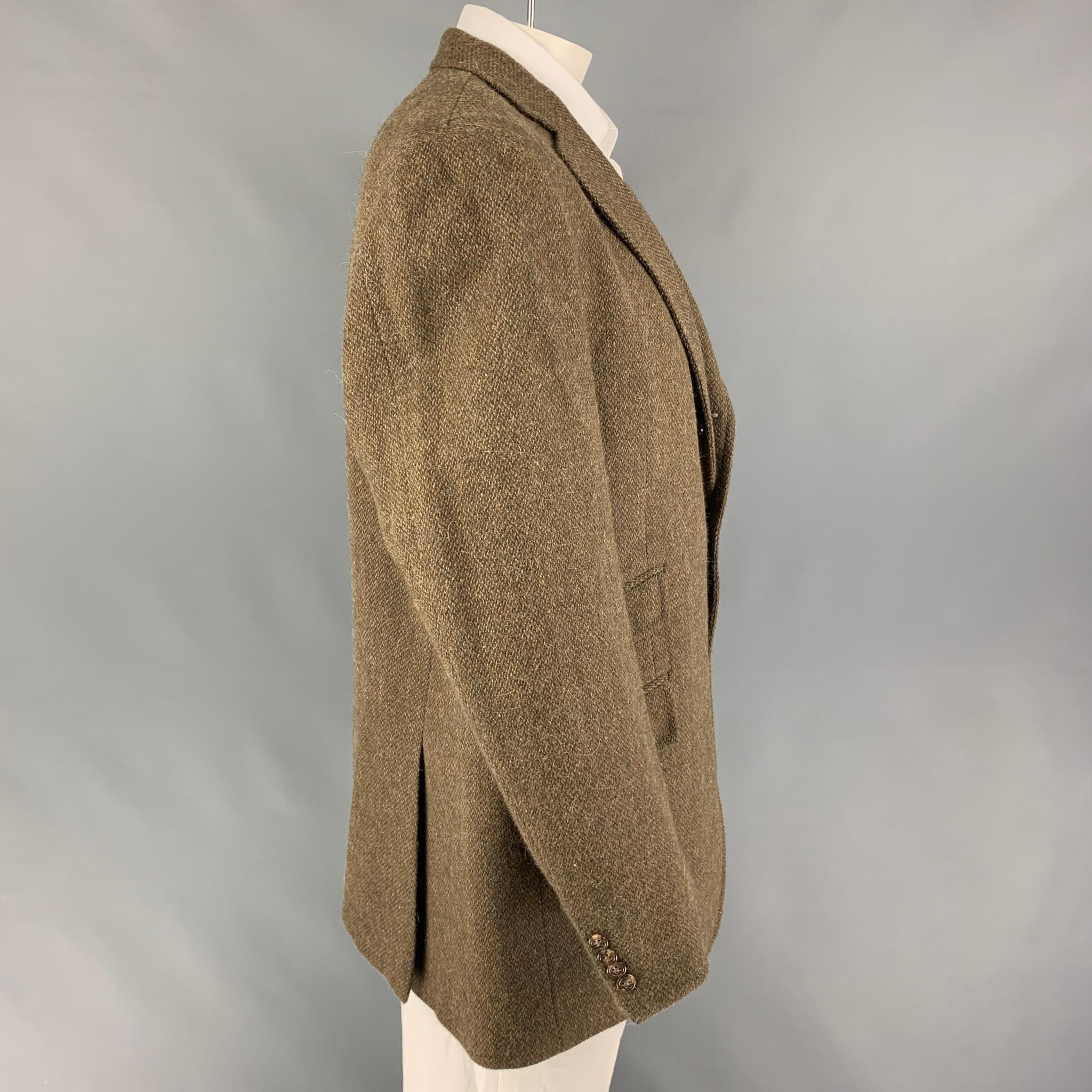 POLO by RALPH LAUREN sport coat comes in a brown wool blend with a full liner featuring a notch lapel, flap pockets, double back vent, and a three button closure. Made in Italy.

Very Good Pre-Owned Condition.
Marked: 46 L

Measurements:

Shoulder: