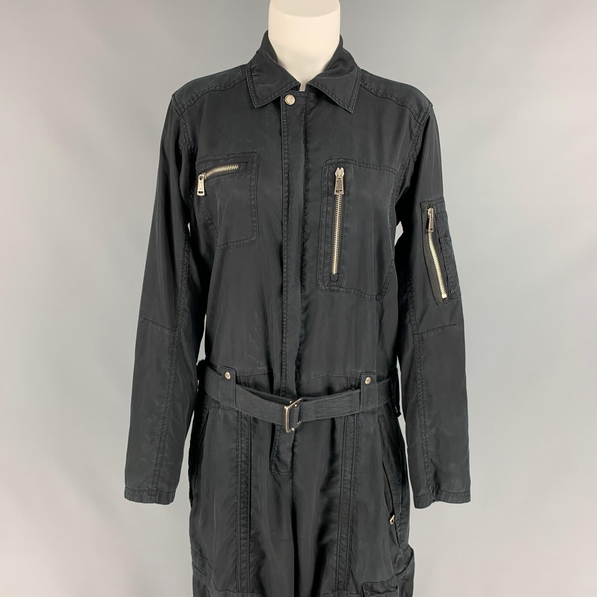 POLO by RALPH LAUREN jumpsuit comes in a black lyocell featuring a belted style, zipper pockets, silver tone hardware, leg strap details, and a hidden snap and full zip closure.

Good Pre-Owned Condition.
Marked: 6
Original Retail Price: