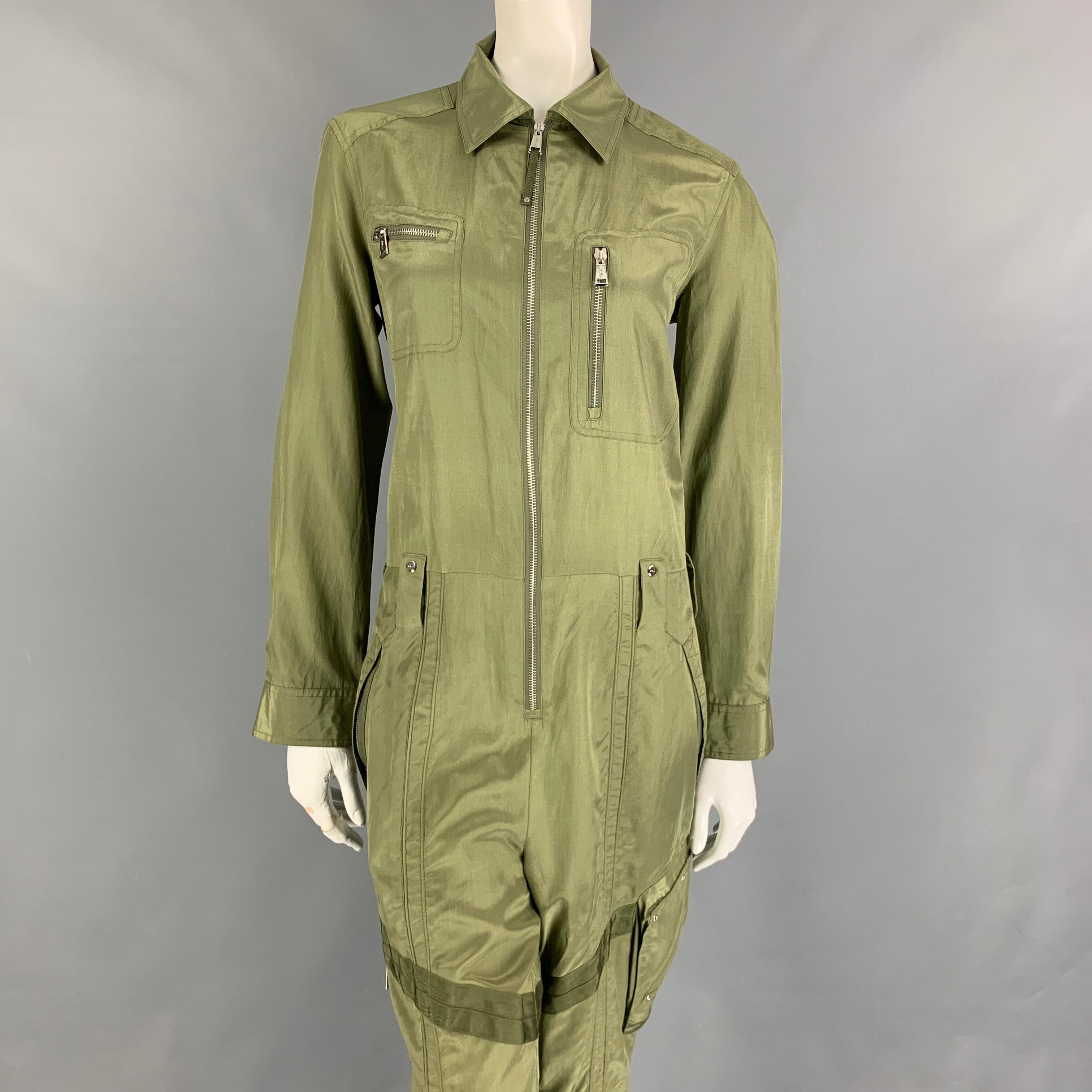 POLO by RALPH LAUREN jumpsuit comes in a moss silk / cotton featuring silver tone hardware, front zippers, long sleeves, spread collar, and a zip up closure. 

Very Good Pre-Owned Condition.
Marked: 8

Measurements:

Shoulder: 17 in.
Bust: 40