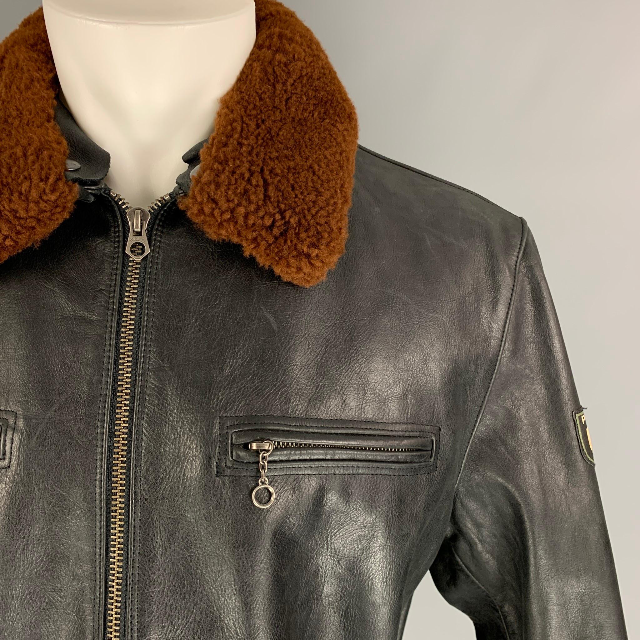 POLO by RALPH LAUREN jacket comes in a black leather with a full liner featuring a brown detachable shearling collar, side zipper details, zipped cuffs, front zipper pockets, and a full zip up closure. 

Very Good Pre-Owned Condition.
Marked: