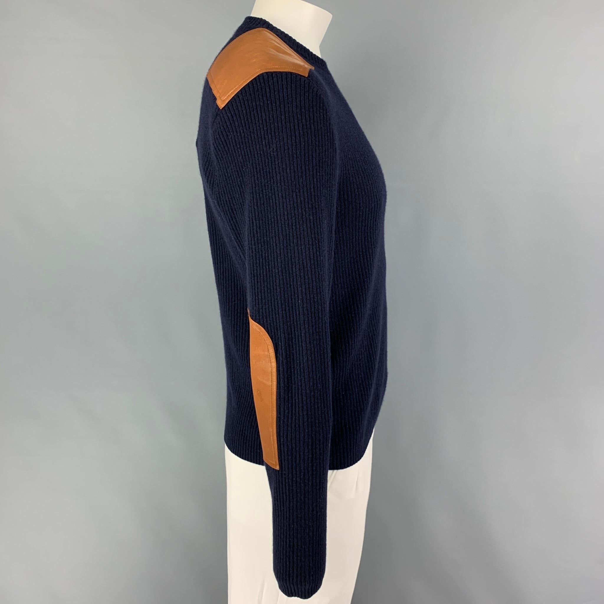 POLO by RALPH LAUREN sweater comes in a navy cashmere featuring tan leather patches and a crew-neck. 

Very Good Pre-Owned Condition.
Marked: L

Measurements:

Shoulder: 19.5 in.
Chest: 42 in.
Sleeve: 27 in.
Length: 25.5 in. 
