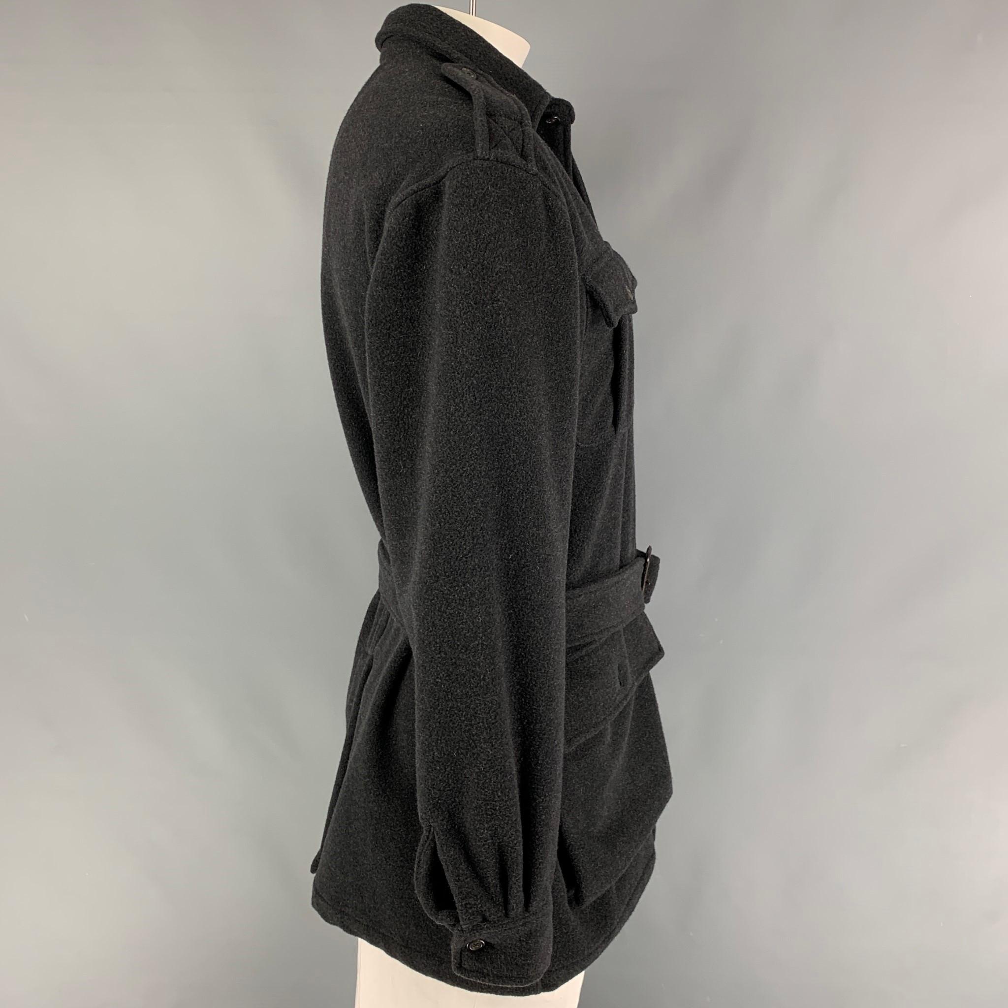 POLO by RALPH LAUREN coat comes in a dark gray cashmere featuring a belted style, epaulettes, patch pockets, single back vent, and a buttoned closure. 

Very Good Pre-Owned Condition.
Marked: M

Measurements:

Shoulder: 21.5 in.
Chest: 48
